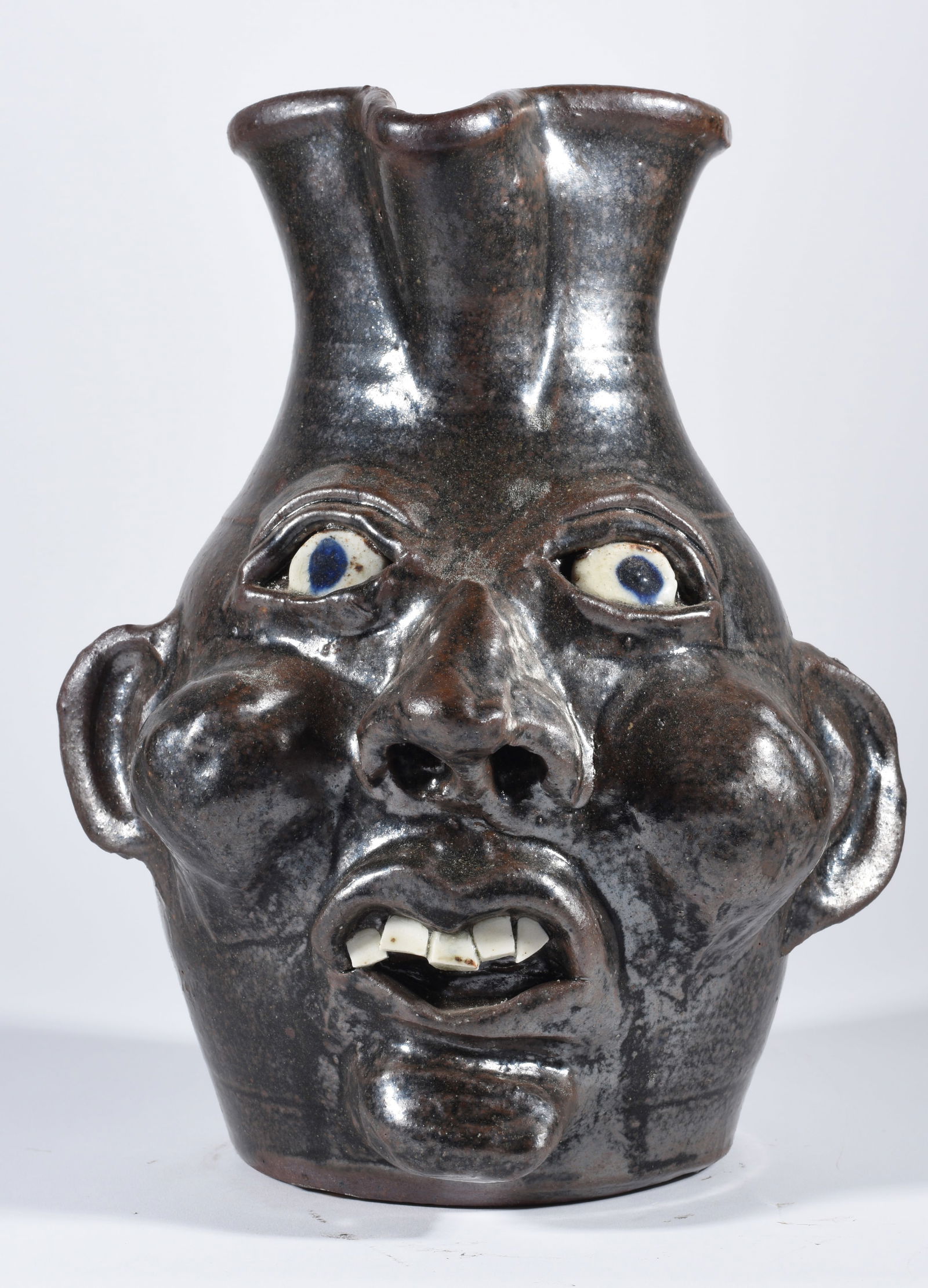 Grace Nell Hewell Face Pitcher: 10.5" face pitcher signed and dated on bottom 2000. one row of broken china teeth. Clay eyes.