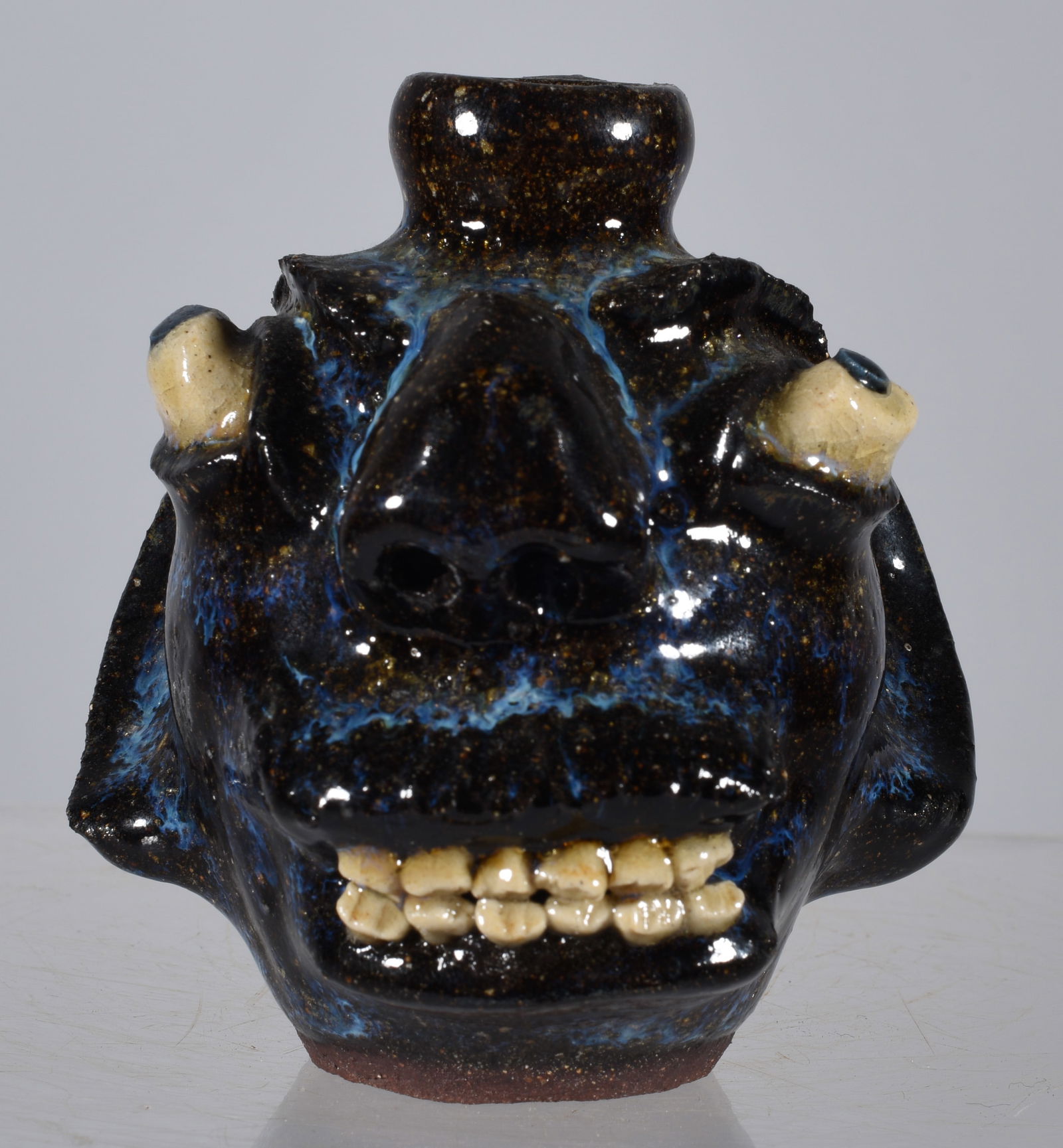 Steve Abee Miniature Face Jug: 3.5" Steve Abee alkaline glaze miniature face jug with a great double row of clay teeth, touches of blue glaze throughout.