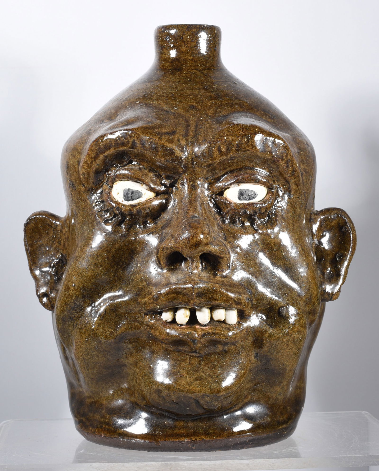 Lanier Meaders Face Jug: 9.5" alkaline glaze, clay eyes and clay teeth. Signed on bottom. Having a fine pronounced facial construction.