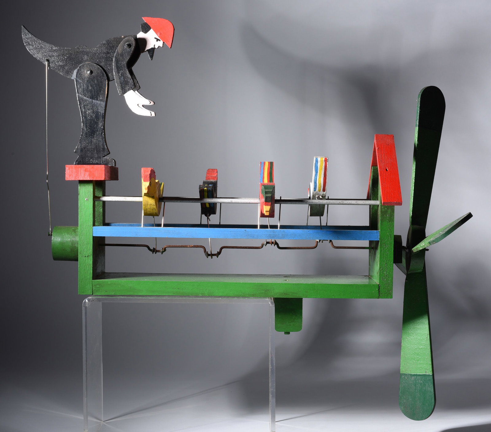 Tom Henry Whirligig: 25" x 16" wood and paint. A mechanical whirligig that operates from the wind.