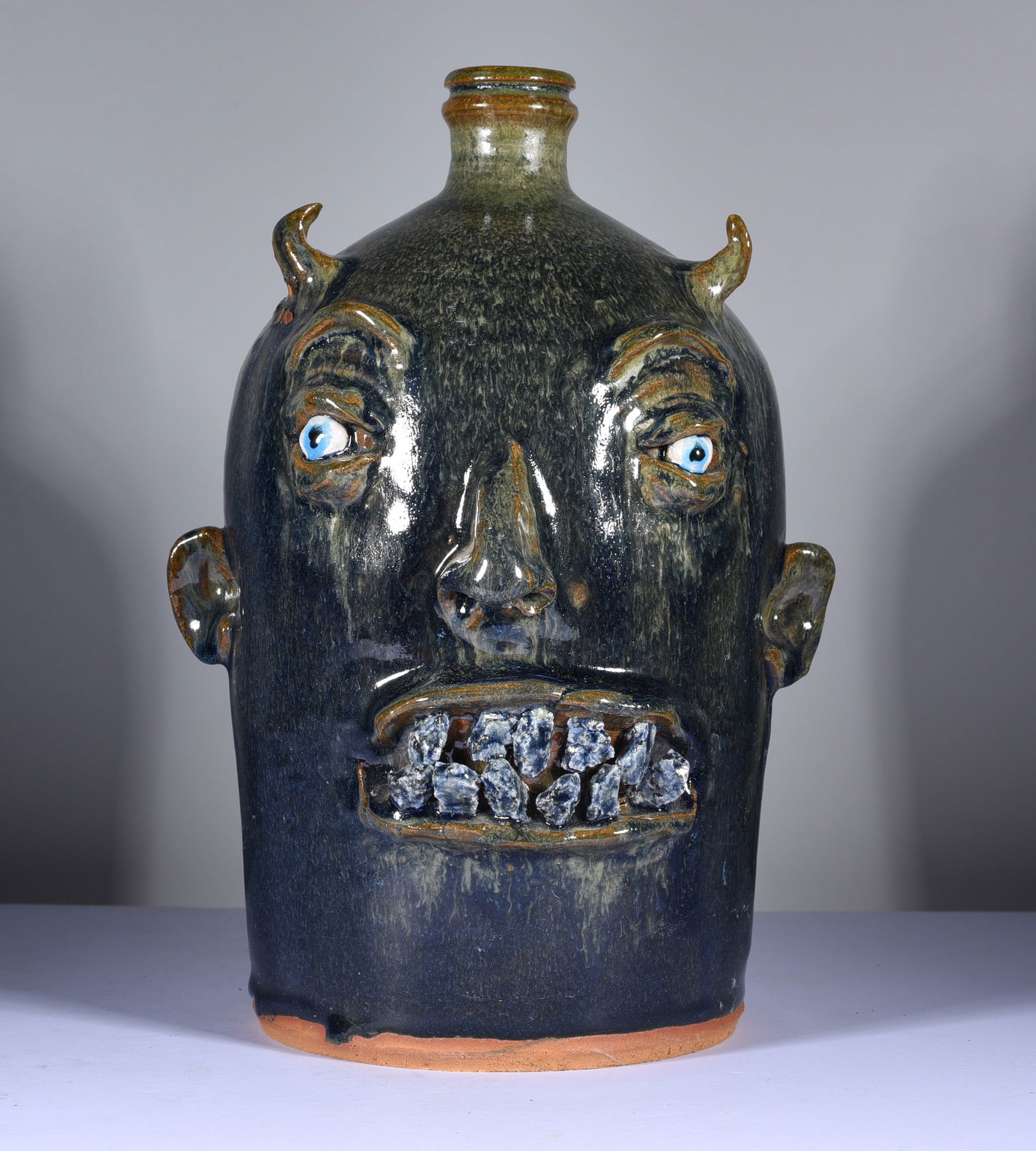 Marvin Bailey Rock Tooth Face Jug: 11" dark green glaze with two rows of rock teeth. Clay eyes. Signed on bottom. Mint condition.