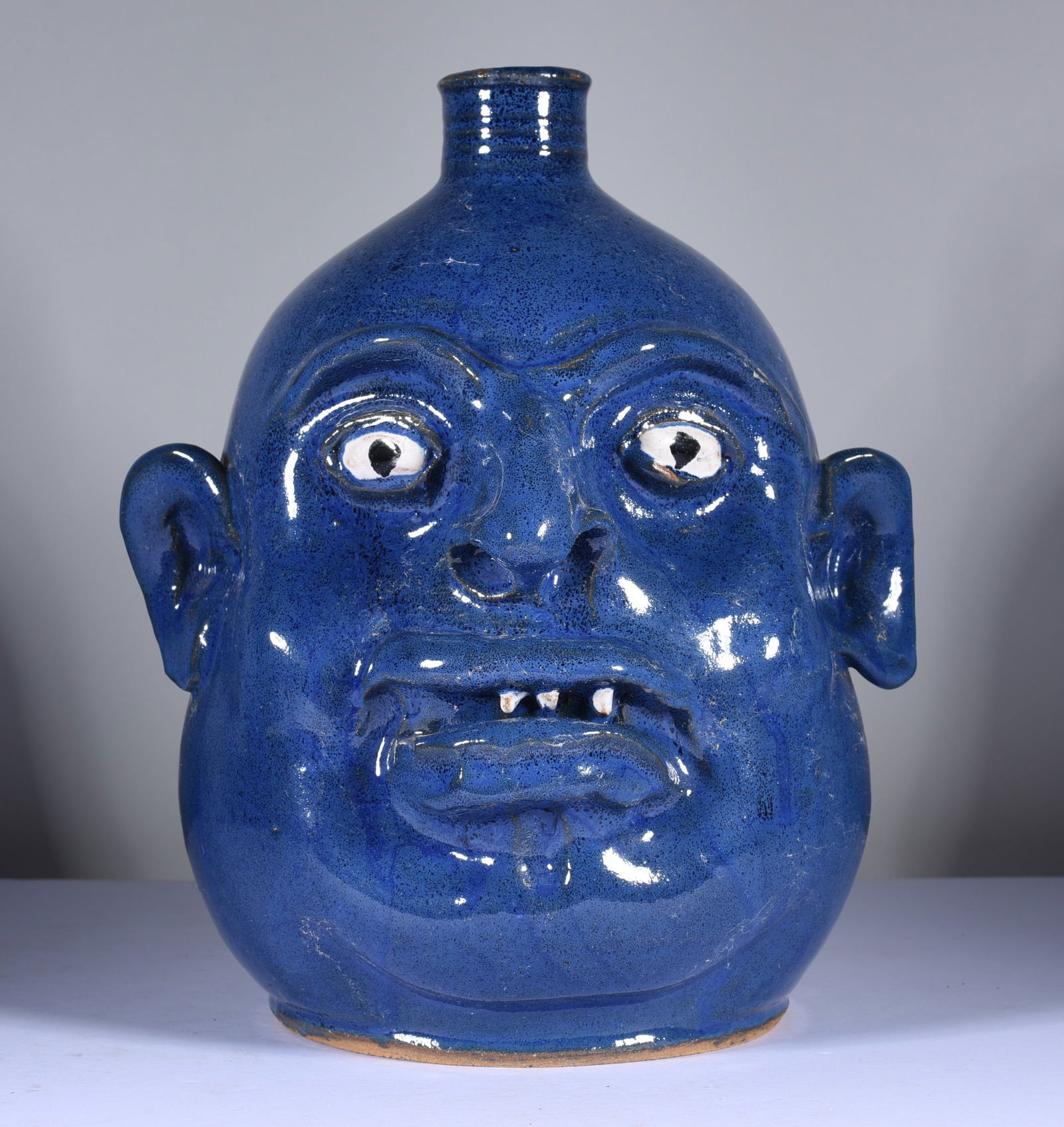 Marvin Bailey Blue Face Jug: 10" a semi rare blue glaze face jug. Not many blue face jugs out there by Marvin. Clay teeth. A nice fat round face jug signed on bottom. Mint condition.