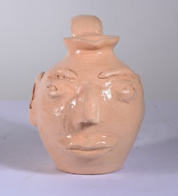 Pottery Face jug signed Gus