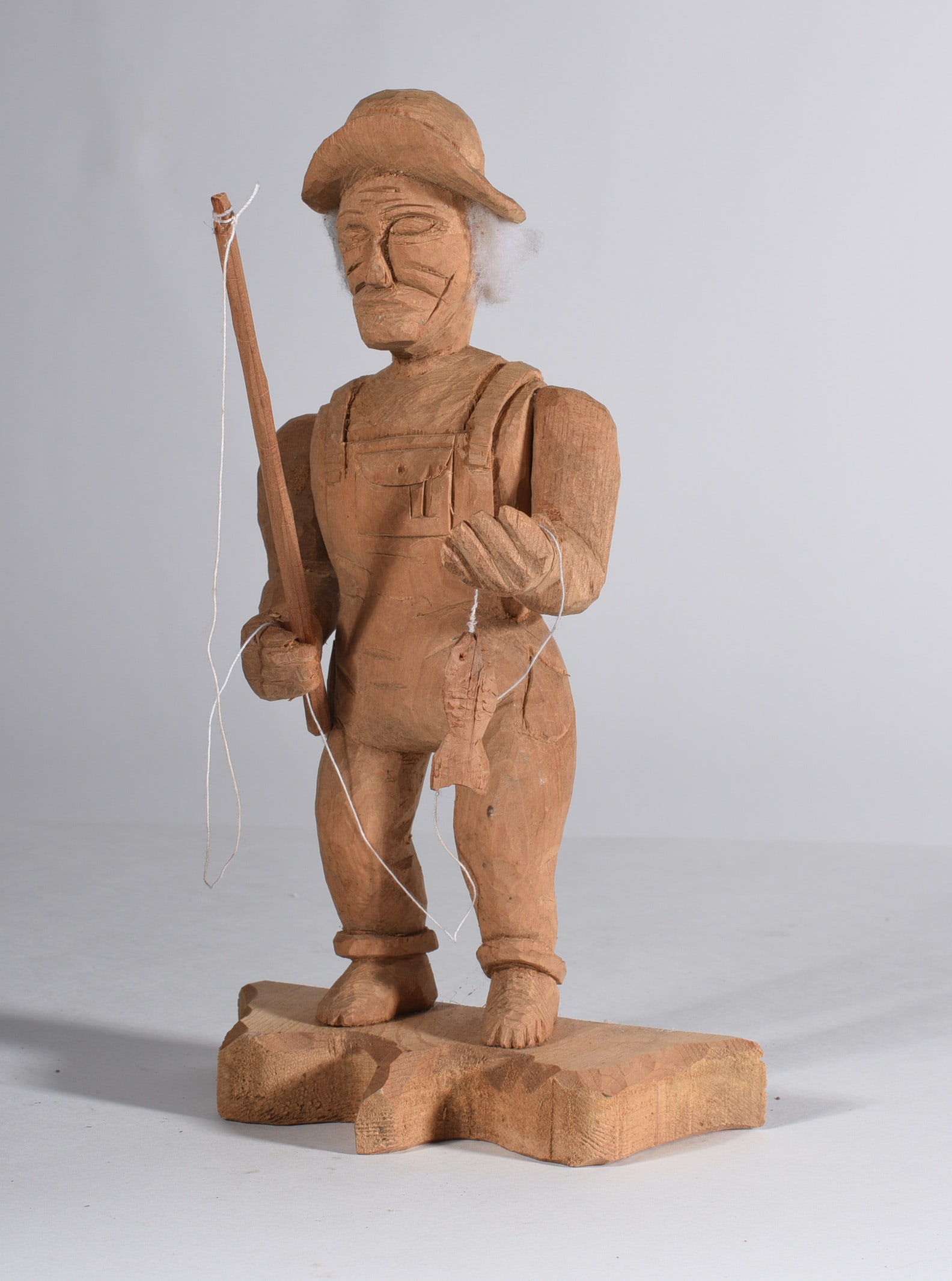 Carved Wooden Fisherman: 8-1/2" carved wood. from the collection of Larry Hackley.