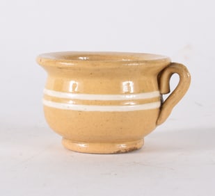 Yellow Ware Miniature Creamer with something inside!