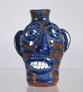 Albert Hodge Miniature Face Jug: swirl miniature face jug by Albert Hodge. All items can be shipped in house see price under condition. The price to right is 3rd party and has nothing to do with us. To get in house shipping select SE