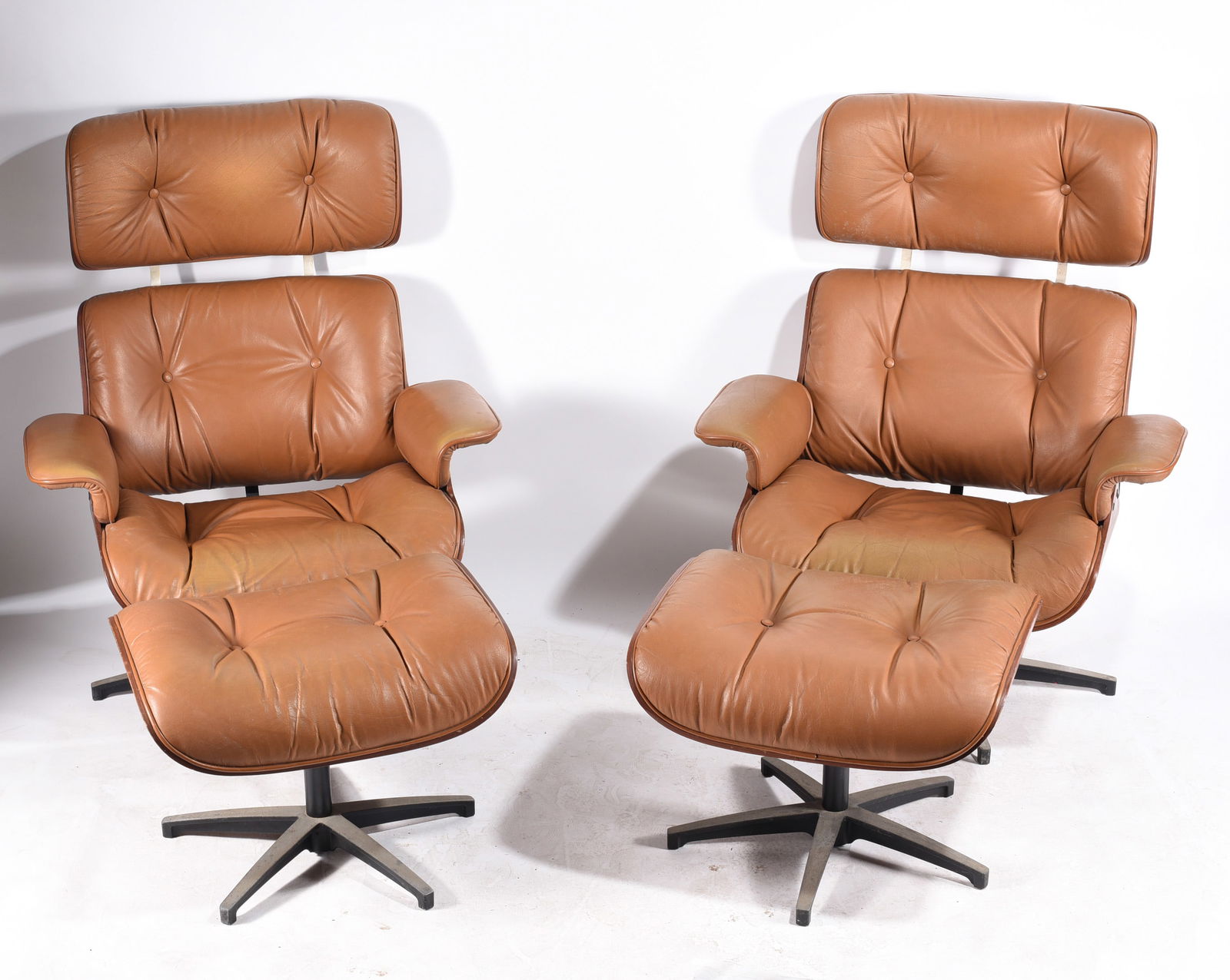 Vintage Plycraft Swivel Lounge Chairs: a wonderful set of plycraft lounge chairs with foot stools. In good overall condition with some scratches and normal wear from use.
