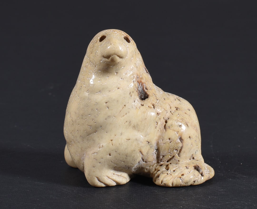 Inuit Carved Whale Bone Figure: These bone carvings were found in an attic trunk wrapped in 1960s newspaper. The collection came straight from the attic to our gallery and we unwrapped and photoed. All of these are small under 7". W