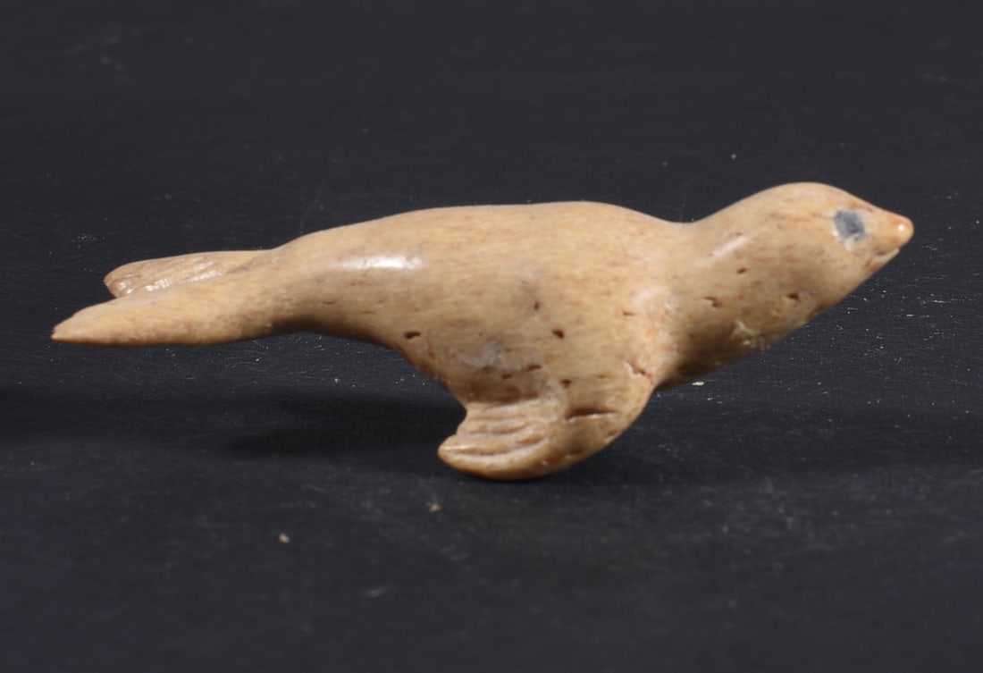 Inuit Carved Whale Bone Figure: These bone carvings were found in an attic trunk wrapped in 1960s newspaper. The collection came straight from the attic to our gallery and we unwrapped and photoed. All of these are small under 7". W