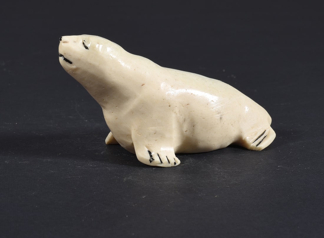 Inuit Carved Whale Bone Figure: These bone carvings were found in an attic trunk wrapped in 1960s newspaper. The collection came straight from the attic to our gallery and we unwrapped and photoed. All of these are small under 7". W