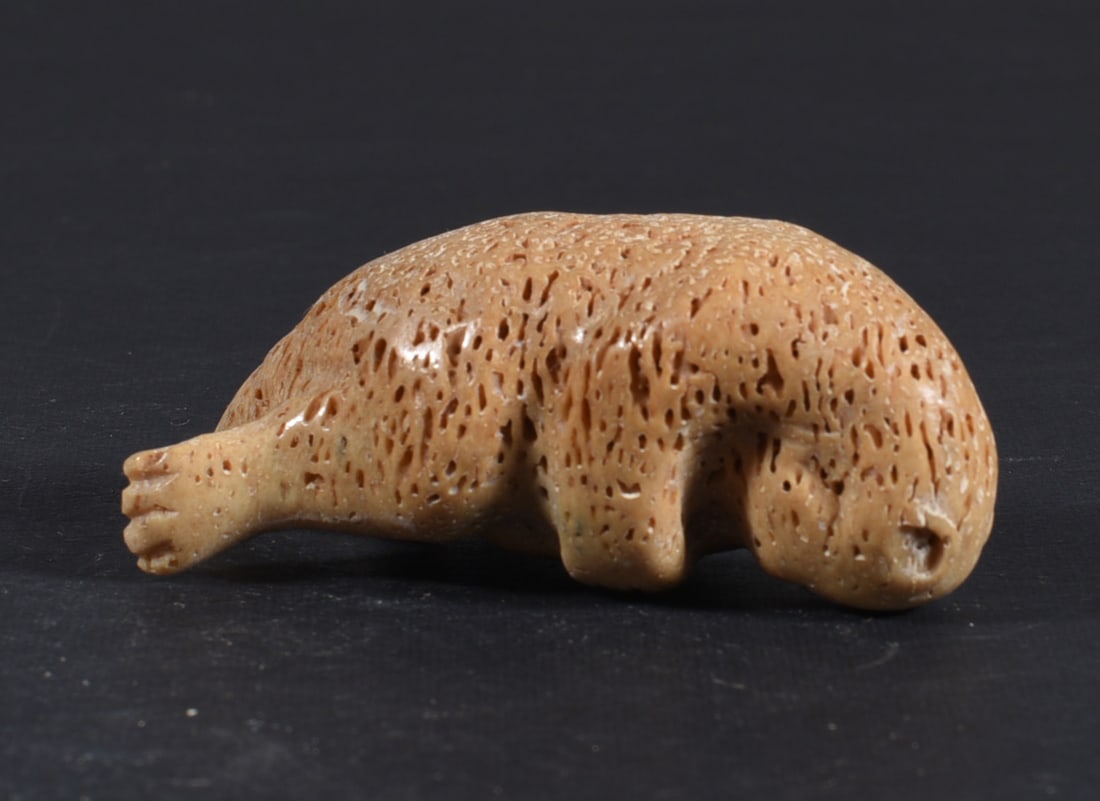 Inuit Carved Whale Bone Figure: These bone carvings were found in an attic trunk wrapped in 1960s newspaper. The collection came straight from the attic to our gallery and we unwrapped and photoed. All of these are small under 7". W