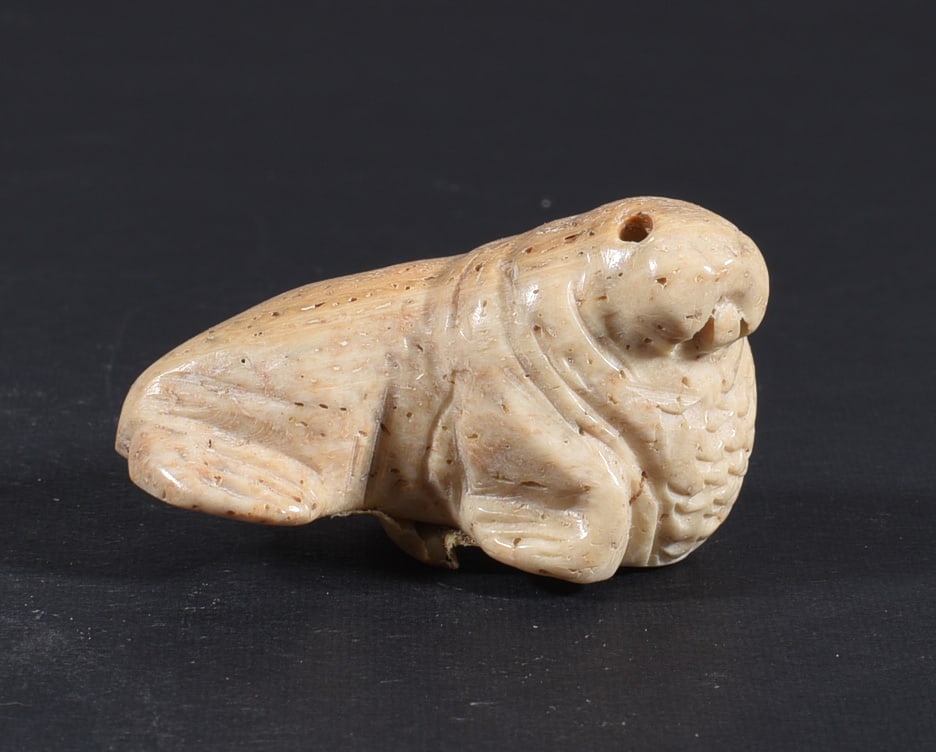 Inuit Carved Whale Bone Figure: These bone carvings were found in an attic trunk wrapped in 1960s newspaper. The collection came straight from the attic to our gallery and we unwrapped and photoed. All of these are small under 7". W