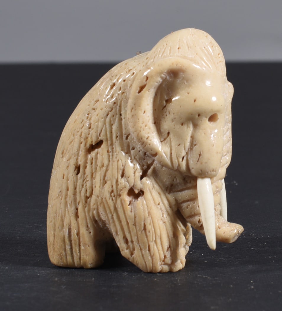 Inuit Carved Whale Bone Figure: These bone carvings were found in an attic trunk wrapped in 1960s newspaper. The collection came straight from the attic to our gallery and we unwrapped and photoed. All of these are small under 7". W