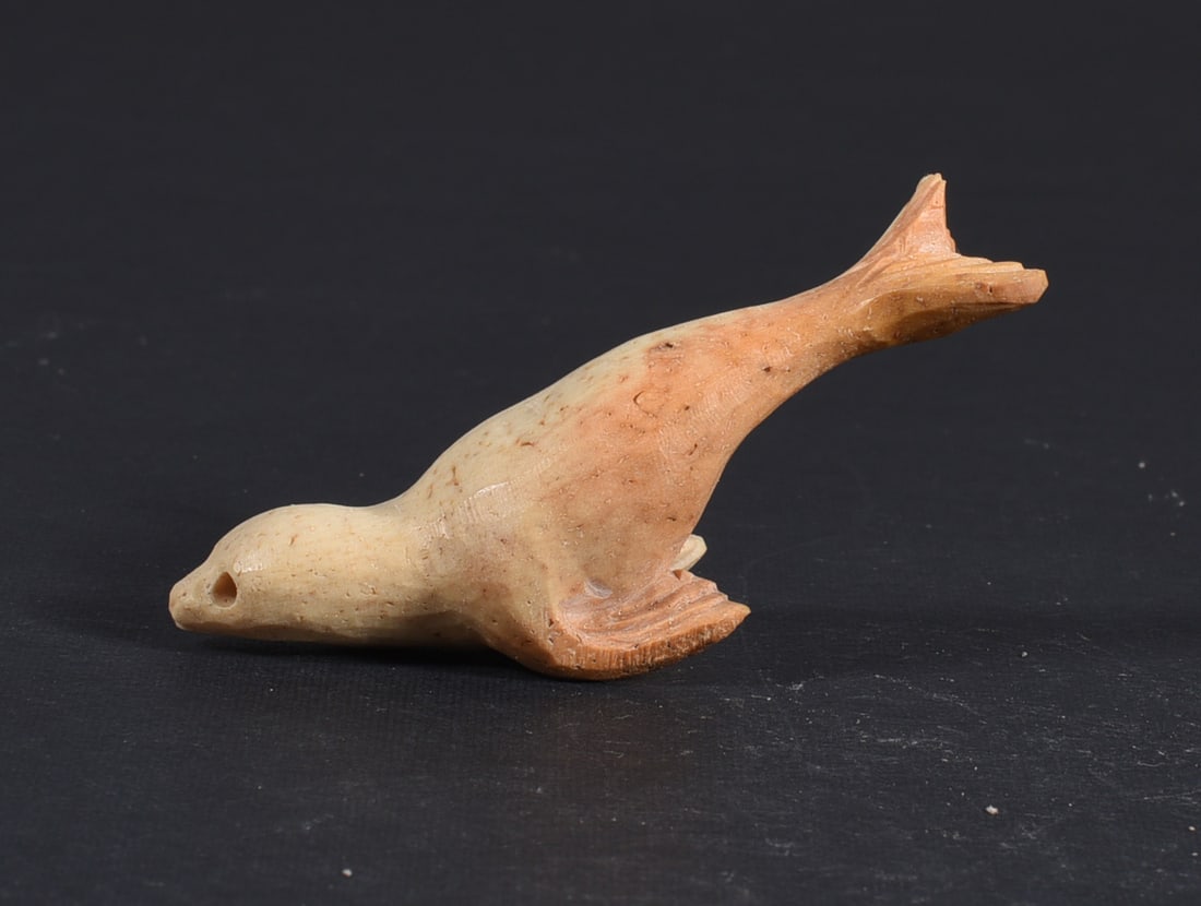 Inuit Carved Whale Bone Figure: These bone carvings were found in an attic trunk wrapped in 1960s newspaper. The collection came straight from the attic to our gallery and we unwrapped and photoed. All of these are small under 7". W