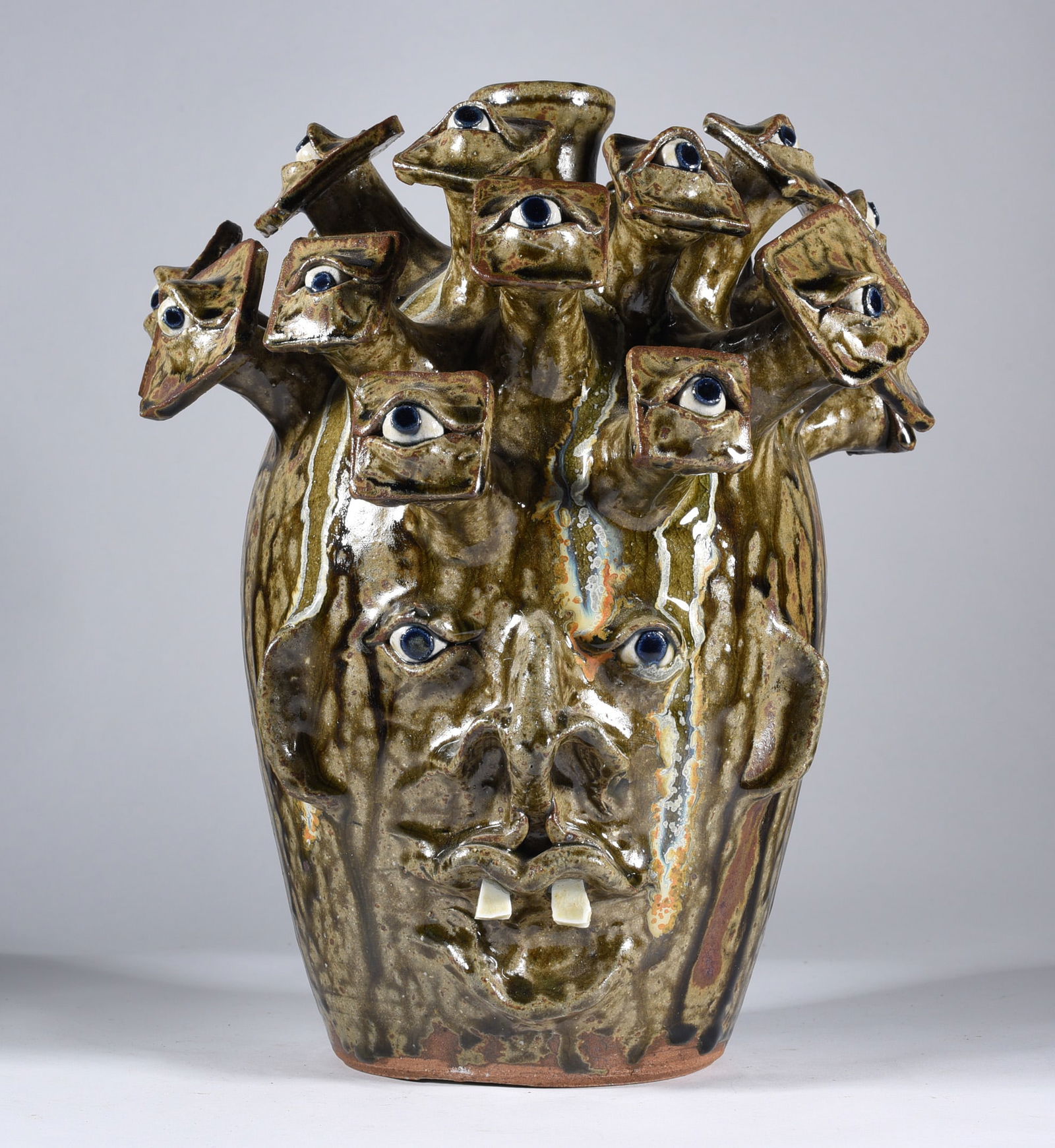 Mike Ball Eyeball Folk Art Face Jug: a folky face jug by Mike Ball. Alkaline glaze with a lot of pottery art going for it! Signed. Two china plate teeth, clay eyes.