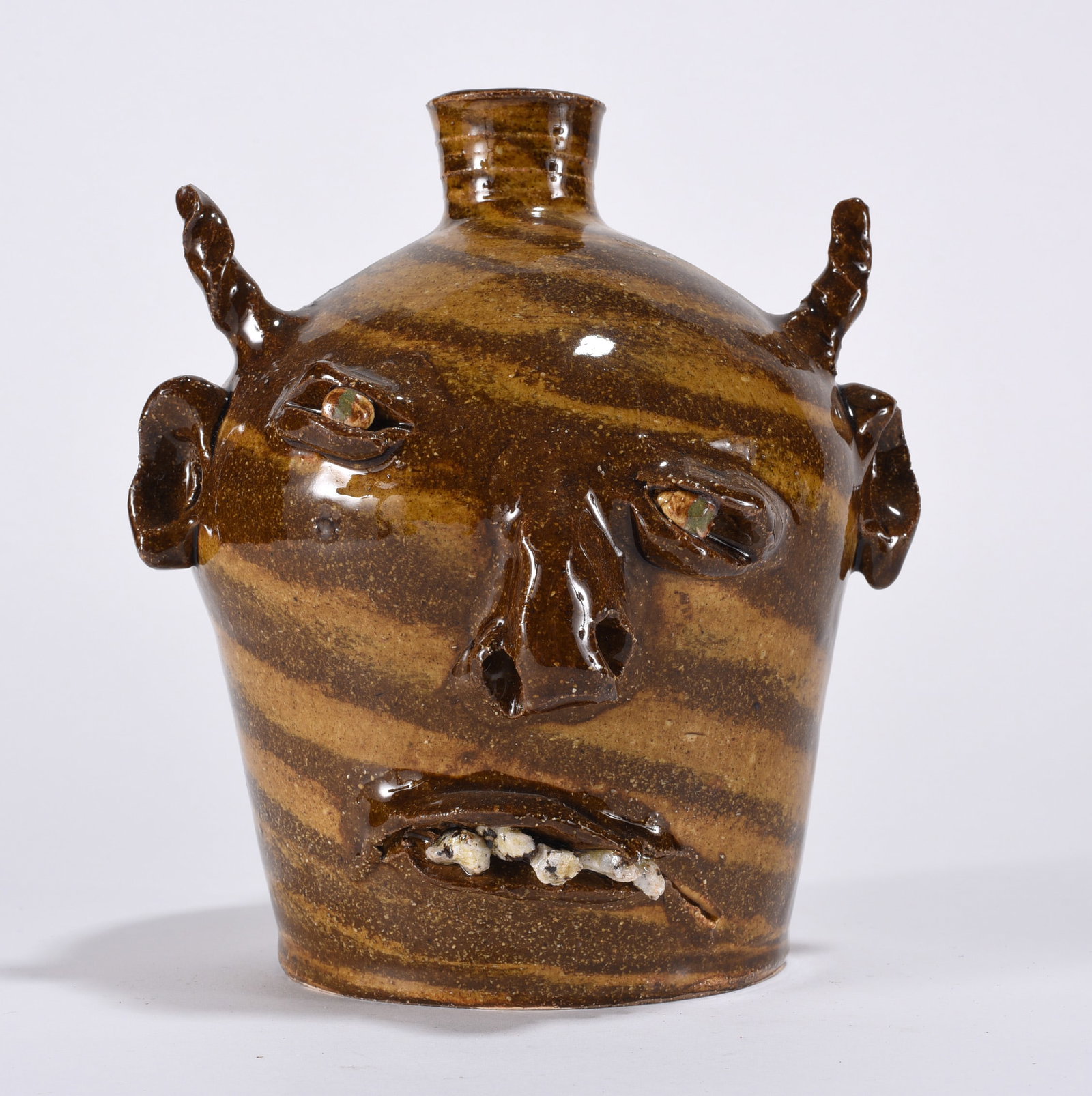 Marvin Bailey Devil Face Jug: 7" early face jug by Marvin Bailey. Rock teeth. Singed. All items can be in house shipped to get in house shipping select SELF ARRANGE. Shipping takes 3 weeks or less but up to 3 weeks.