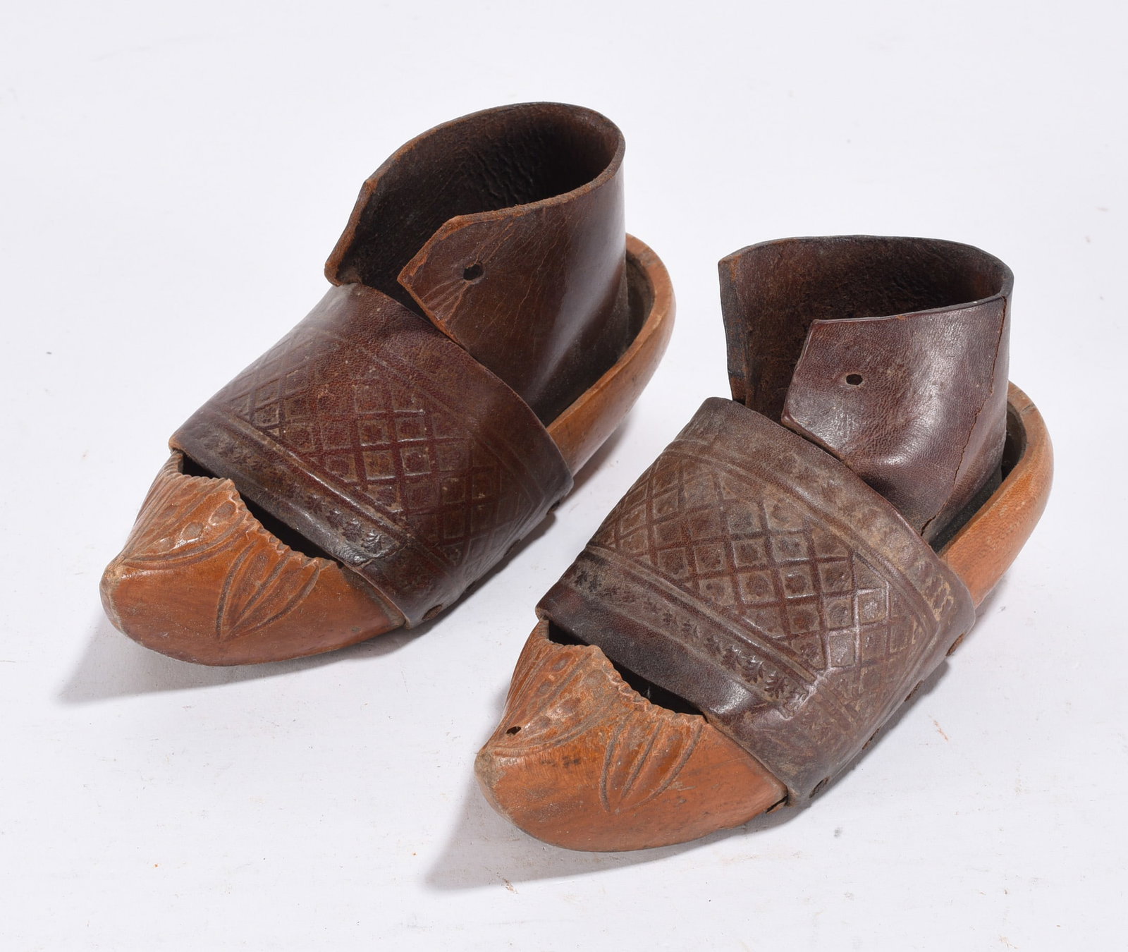 Ornate Carved Wooden Shoes: carved wooden shoes with leather. Avg. 4"