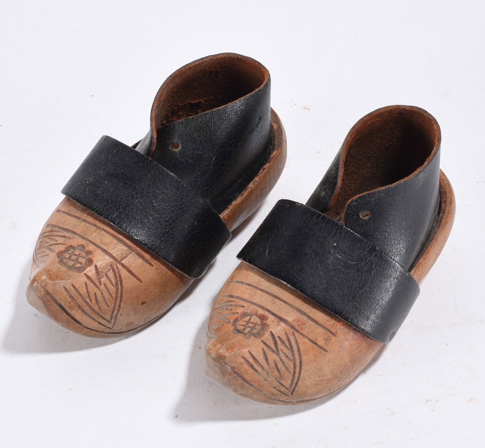 Ornate Carved Wooden Shoes: carved wooden shoes with leather. Avg. 4"