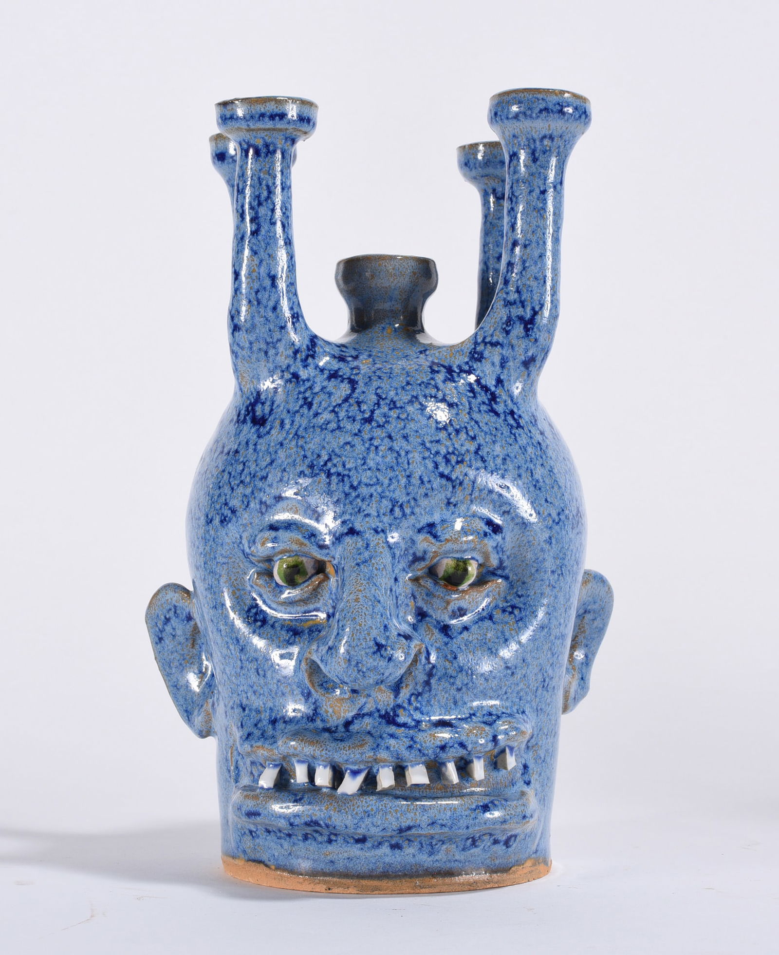 Marvin Bailey Candelabra Face Jug: 9" - a candelabra face jug in an amazing blue glaze. Darker specks of blue surrounding the top. China plate teeth and clay eyes. Signed on bottom.