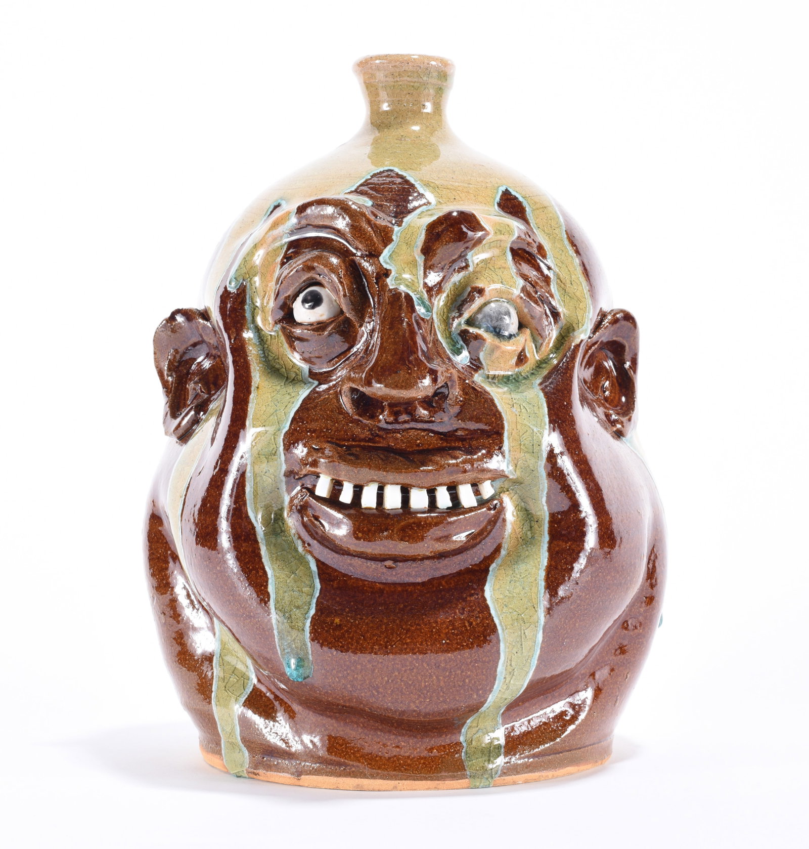 Marvin Bailey Face Jug: 11" a fantastic face jug by Marvin Bailey, with what looks like a lazy eye (the glaze ran over the eye giving it a unique effect.) This face jug has a brown glaze base with a good bit of green run. Ch