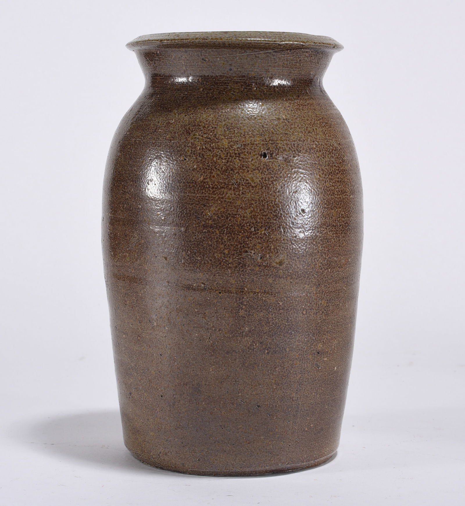 Piedmont North Carolina Salt Glaze jar ca. 1861: salt glaze jar piedmont north carolina. Chunk of clay from kiln stuck to body of jar. Condition is good, no cracks or chips.