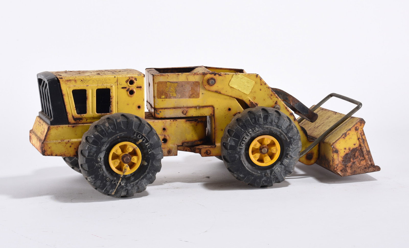Vintage Pressed Steel Toy Excavator: Vintage pressed steel toy excavator with articulated arm, showing heavy surface wear.