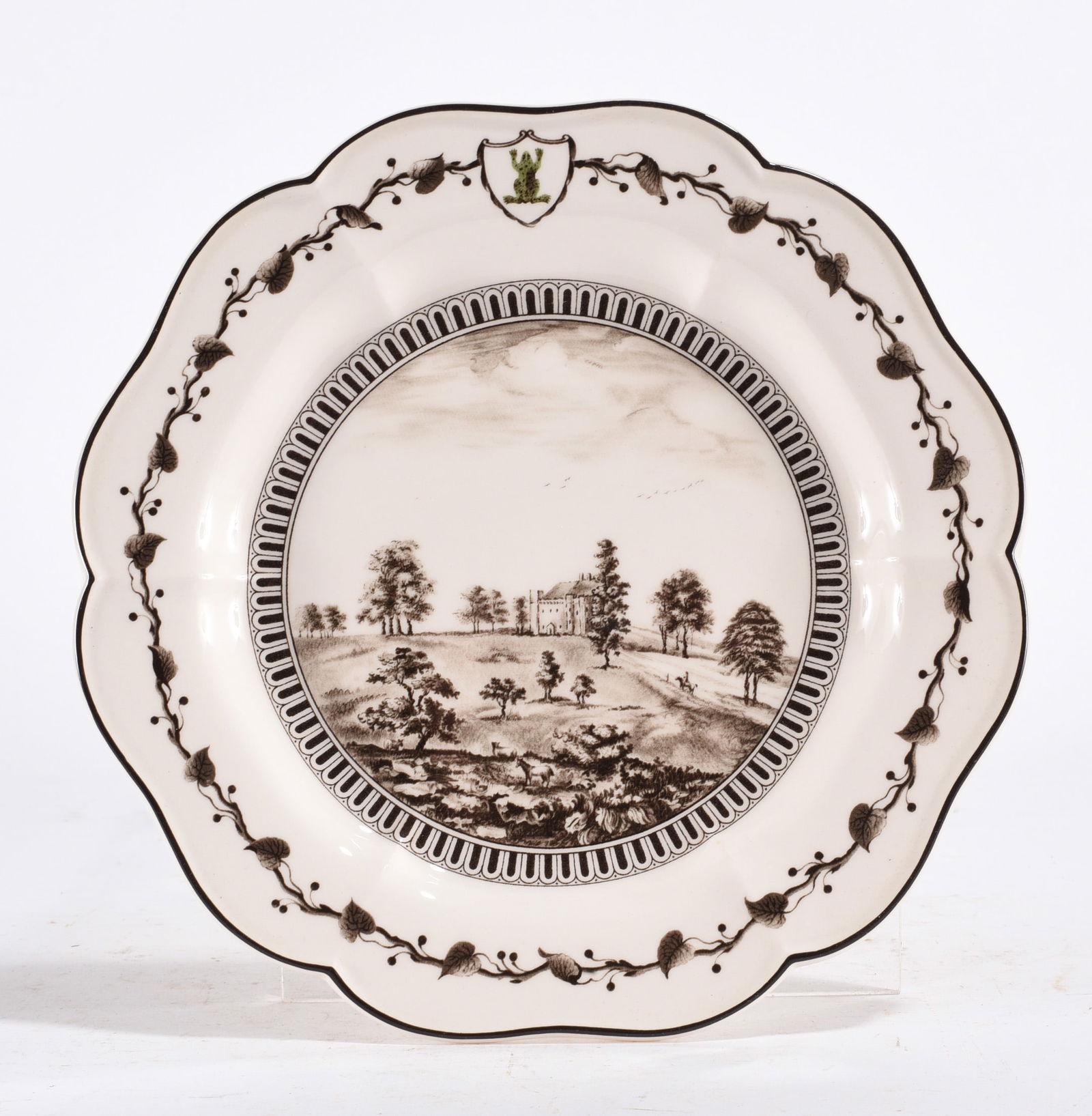 Transferware Plate – Landscape Scene: Black transferware plate featuring pastoral landscape with central building and decorative border. Likely 19th century.