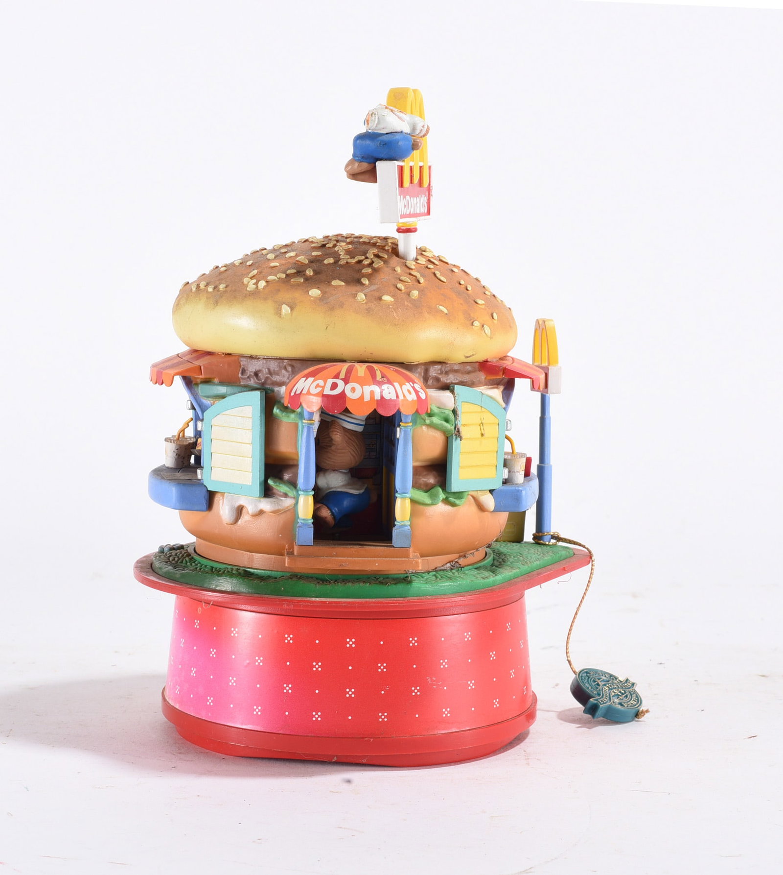 McDonald’s Musical Toy: Plastic McDonald’s themed musical or wind-up toy in the form of a hamburger stand. Late 20th century.