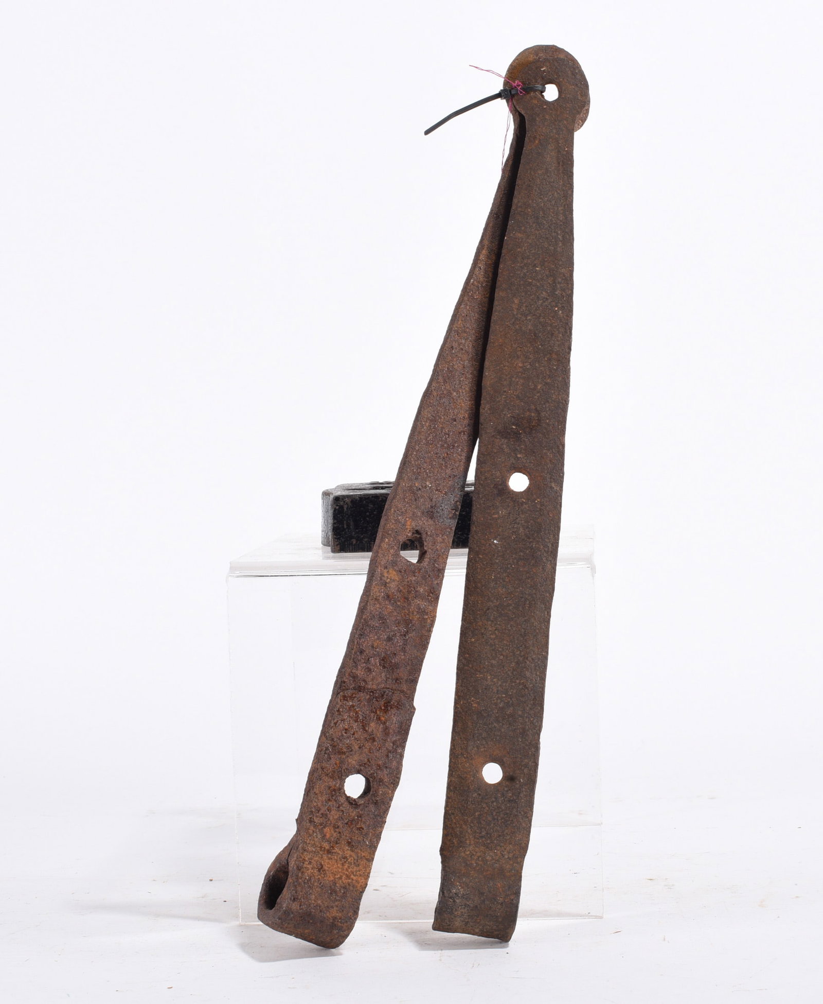 Forged Iron Hinges: Pair of large hand-forged iron strap hinges with heavy rust patina. Likely 18th–19th century architectural hardware.
