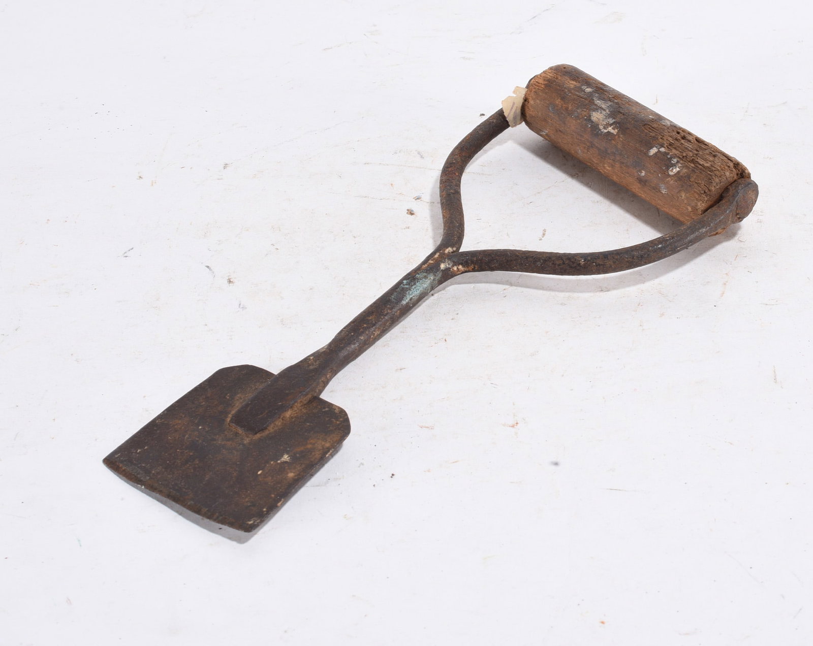 Hand Forged Curved Blade Tool: Vintage garden hoe with iron head and short wood grip handle, surface rust present