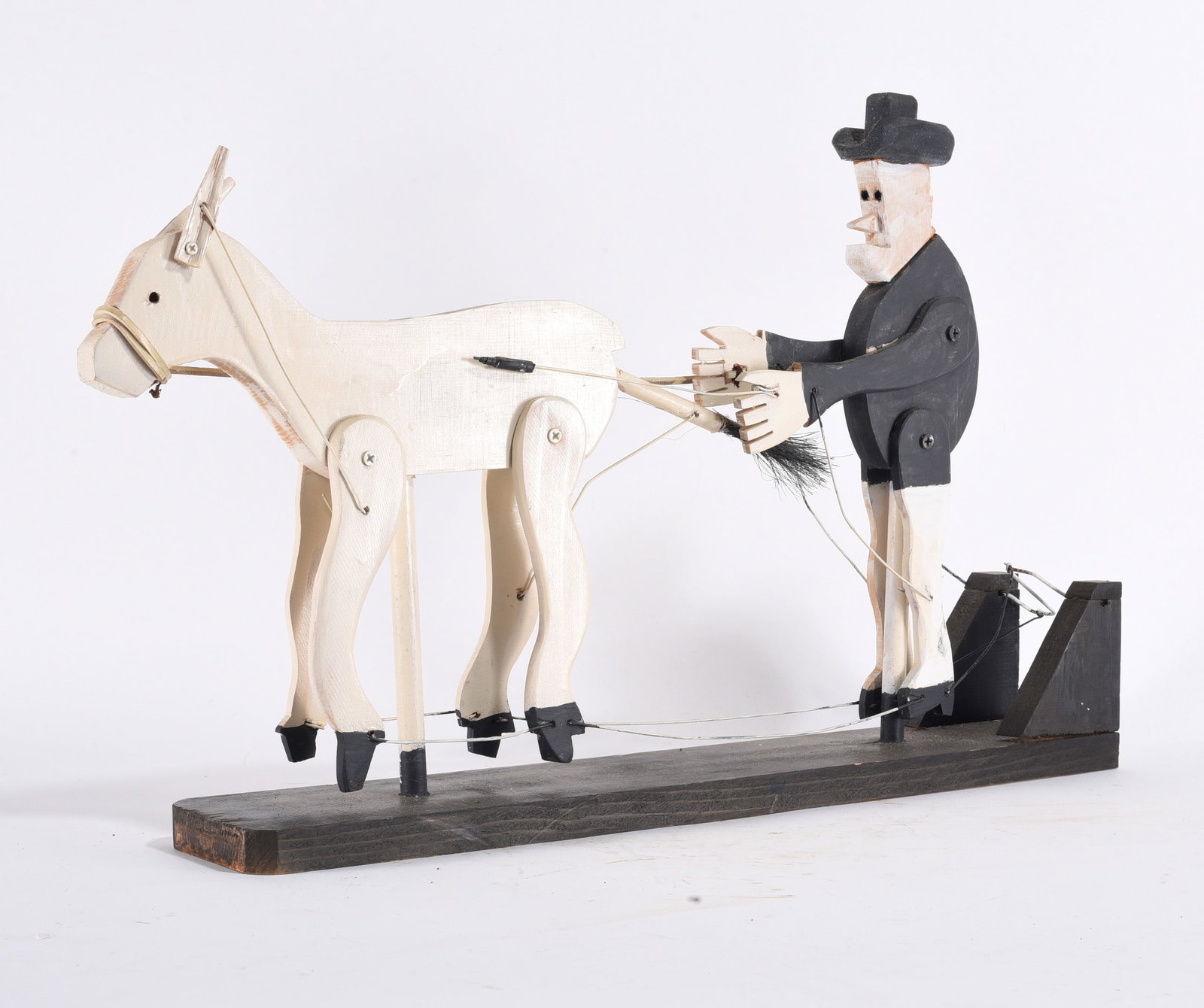 Folk Art Creation of Man and Mule: 14" - a folk art creation of a man behind a mule. Carved wood and paint.signed on bottom Jones Todd dated 1992. please see photos for condition. All items are in estate condition We do offer in house