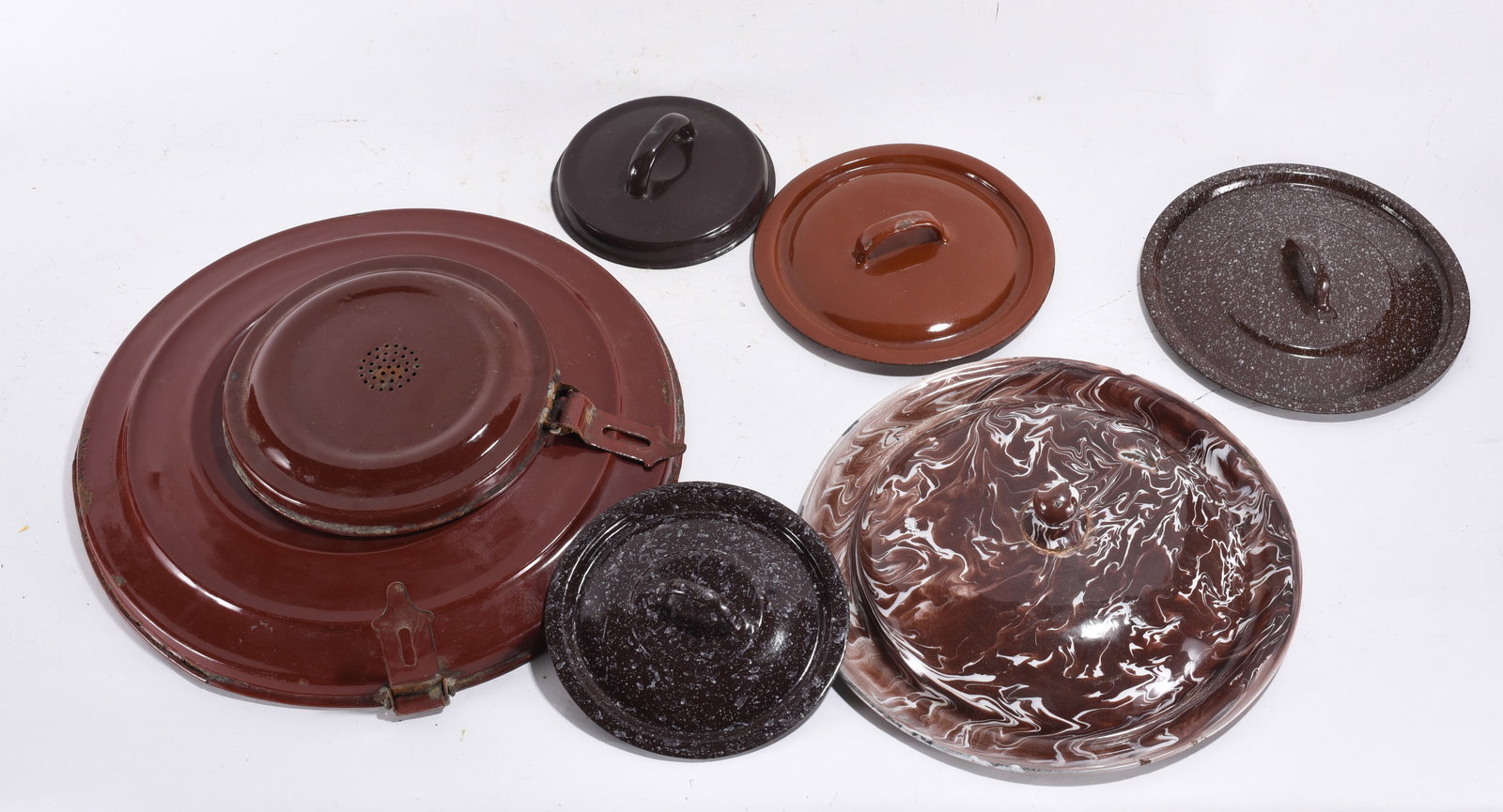 Brown & Marbled Enamel Lid Assortment: 13" -- Assorted brown and marbled enamel lids including swirl pattern example. Mixed sizes with noticeable wear.