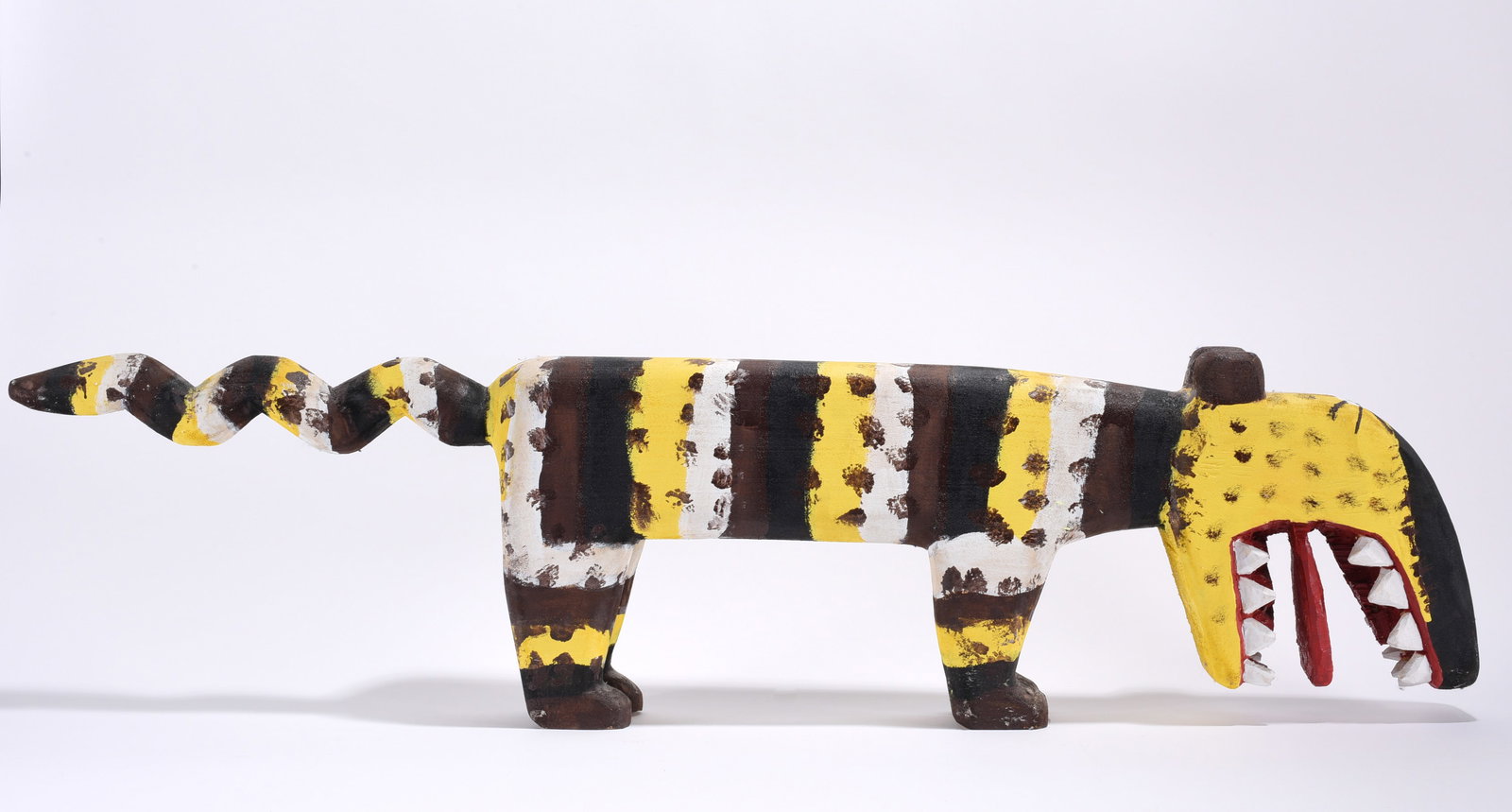 Minnie Adkins Carved Animal: 11"x40" large wooden animal carved and painted. Signed and dated 1999. please see photos for condition. All items are in estate condition We do offer in house shipping for items under 36" boxes