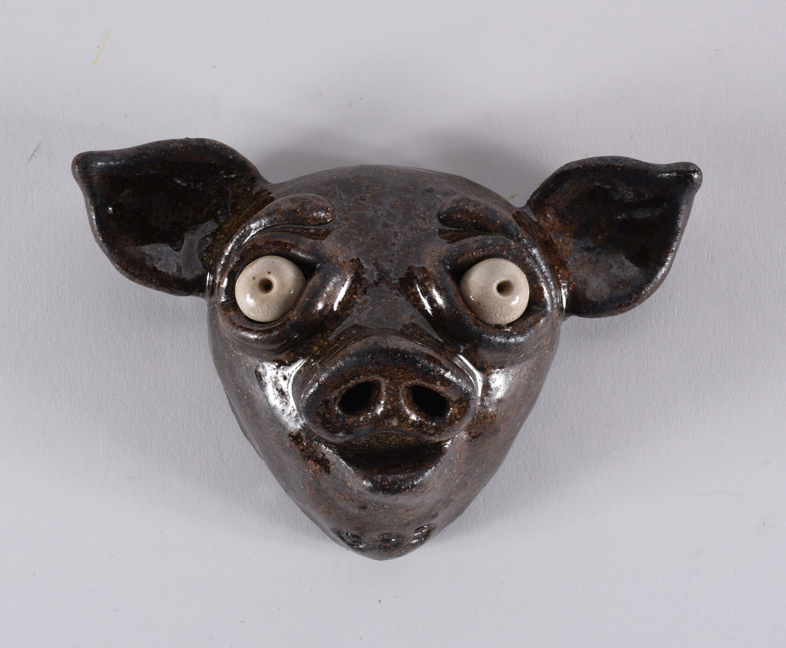 Michael Gates Pottery Pig Face: 4" pottery pig face. Michaael Gates is a descendent of the Reinhardt family of potters in North Carolina. please see photos for condition. All items are in estate condition We do offer in house shippi