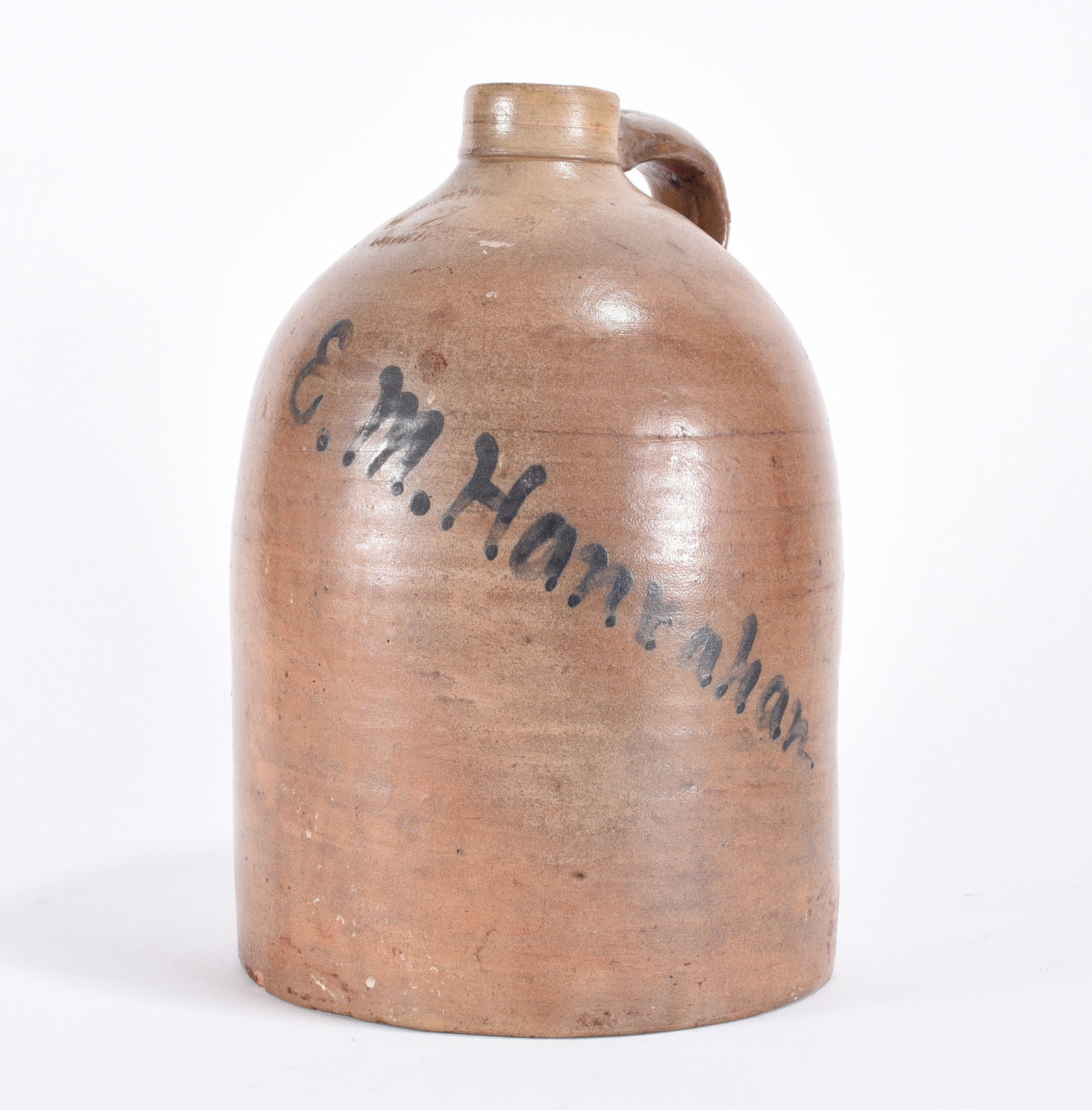 EM Hanrahan Signed Stoneware Jug: 13" one gallon stoneware jug signed EM Hanrahan in blue slip. also stamped on shoulder NY. please see photos for condition. All items are in estate condition We do offer in house shipping for items un