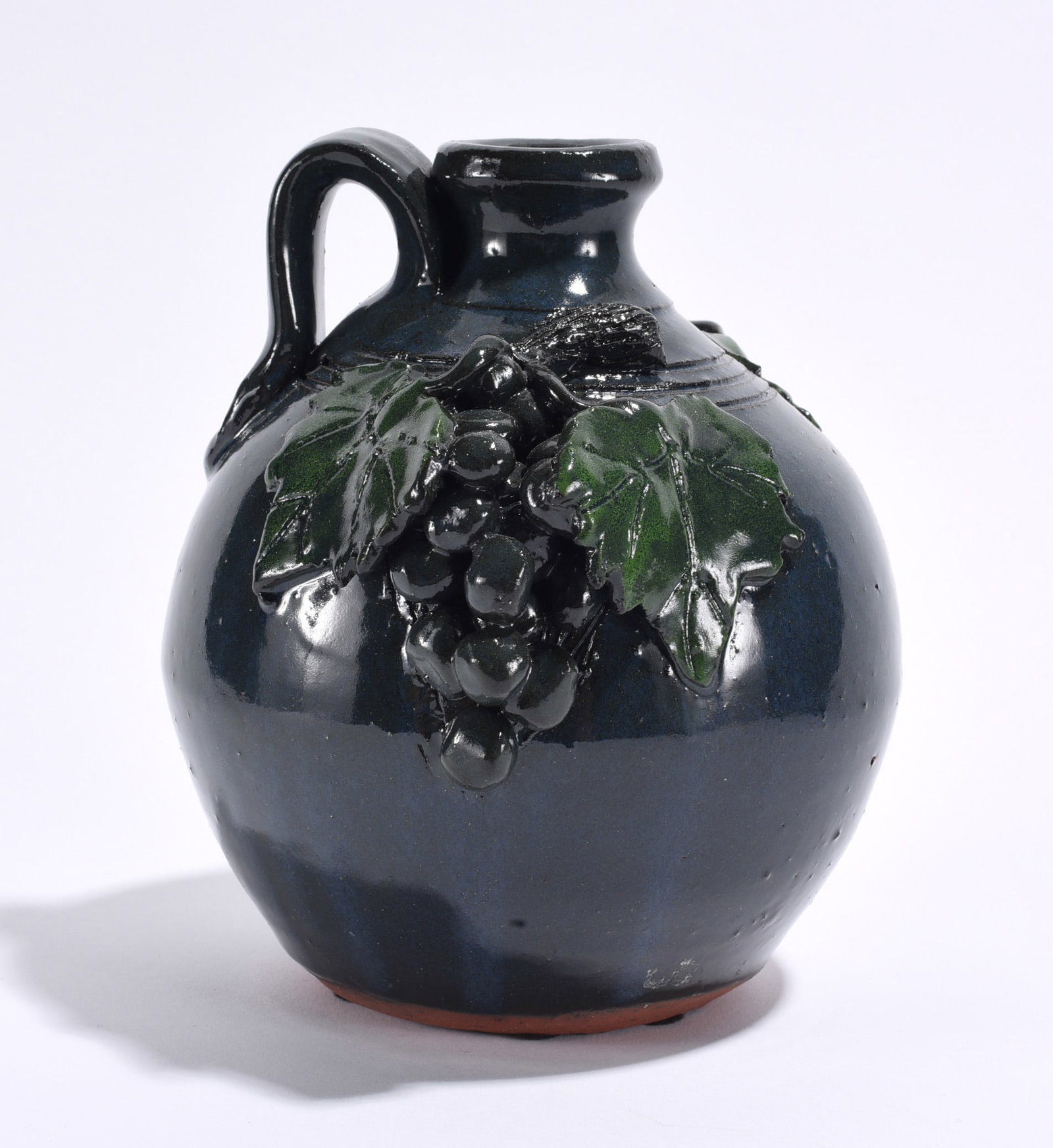 Bobby Ferguson Applied Grape Jug: 7" pottery jug with applied grapes, signed on bottom. We do offer in house shipping for items under 36" boxes 10"x10"x10" we can ship for around $21. boxes 18x18x18 we can ship for around $56 - $65. t