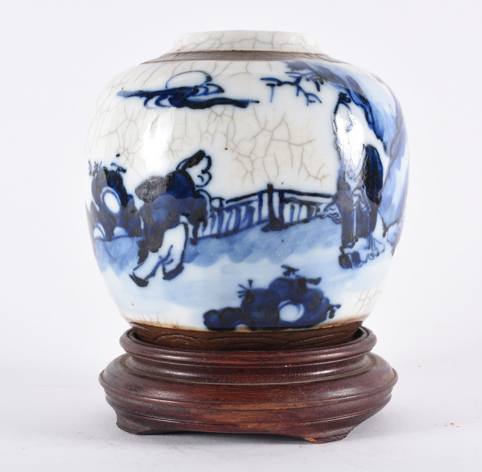Chinese Blue and White Crackle Glaze Ginger Jar on Stand: 7" Small porcelain ginger jar decorated in underglaze blue with figural and landscape scene, featuring crackle glaze throughout. Mounted on a fitted wooden stand. Likely 20th century decorative exampl