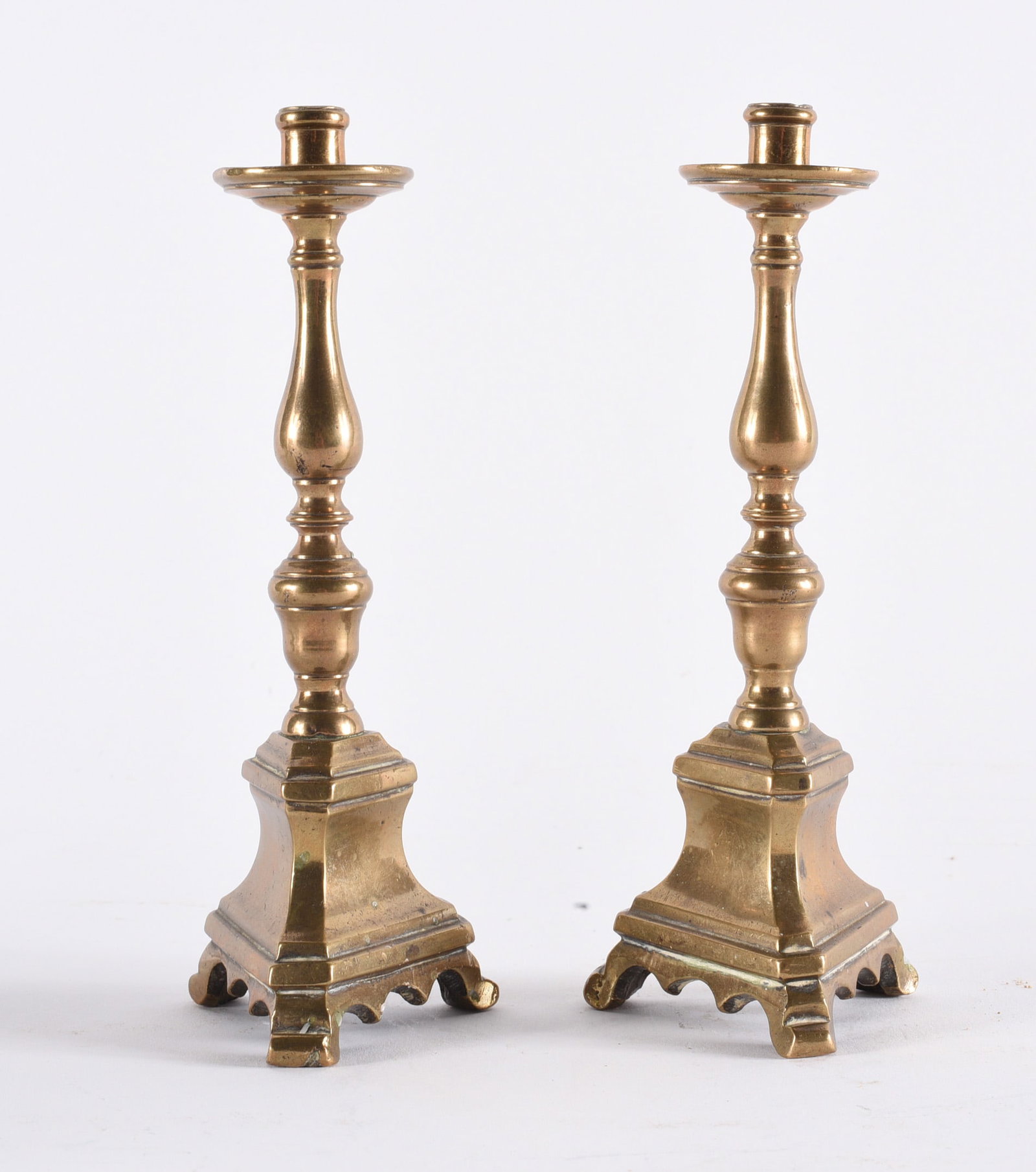 Pair Brass Candlesticks with Square Bases: 7" Pair of brass candlesticks with turned shafts and square stepped bases. Classic traditional form, likely 19th to early 20th century, showing patina consistent with age and use.