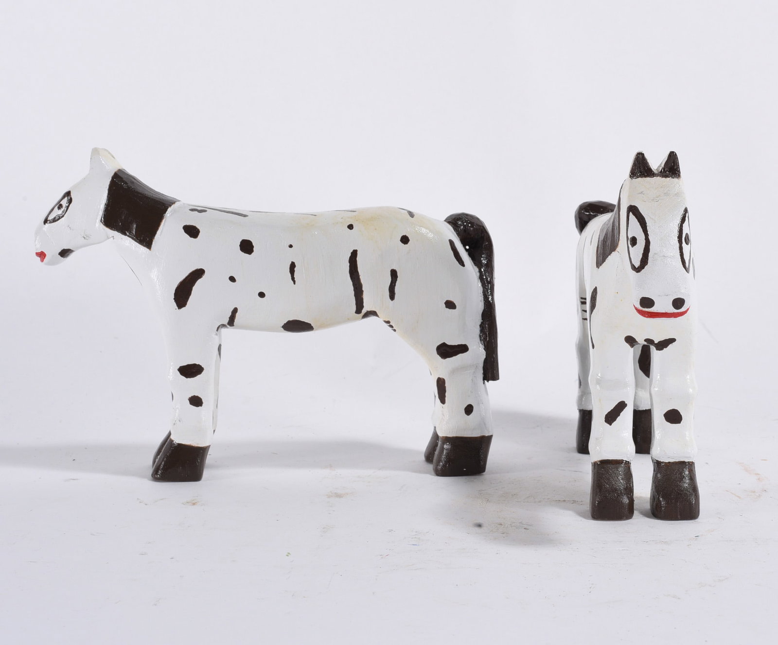 Folk Carved Wooden Horses: Both 5"x8" --carved wood and paint. please see photos for condition. All items are in estate condition We do offer in house shipping for items under 36" boxes 10"x10"x10" we can ship for around $21.