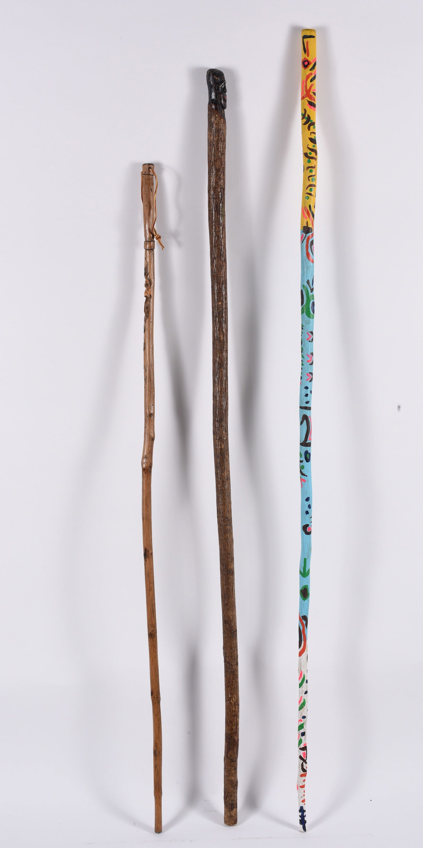 Group of Folk Art Canes: Largest 62" - one of the canes is by Gary Yost. painted and carved folk canes. please see photos for condition. All items are in estate condition We do offer in house shipping for items under 36" boxe