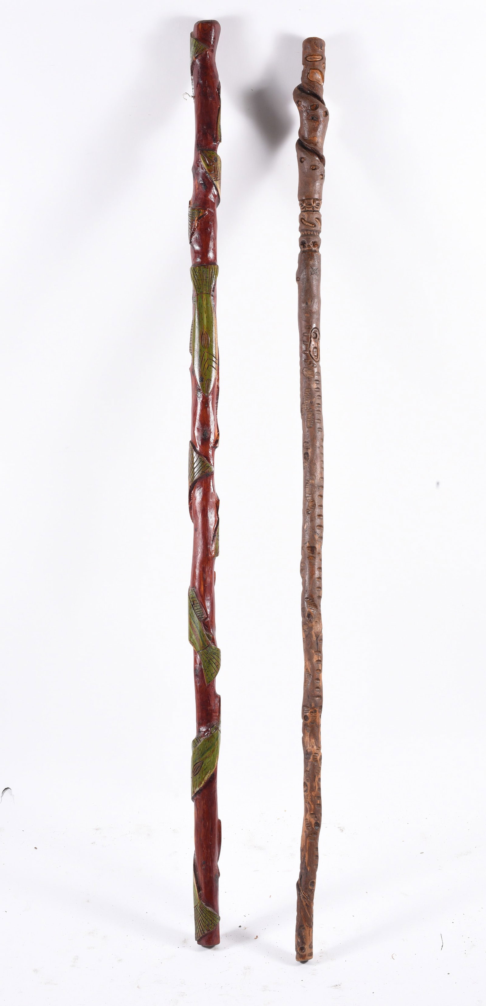 Folk Art Carved Large Canes: 60" -- long canes, one has fish carved around it. please see photos for condition. All items are in estate condition We do offer in house shipping for items under 36" boxes 10"x10"x10" we can ship for