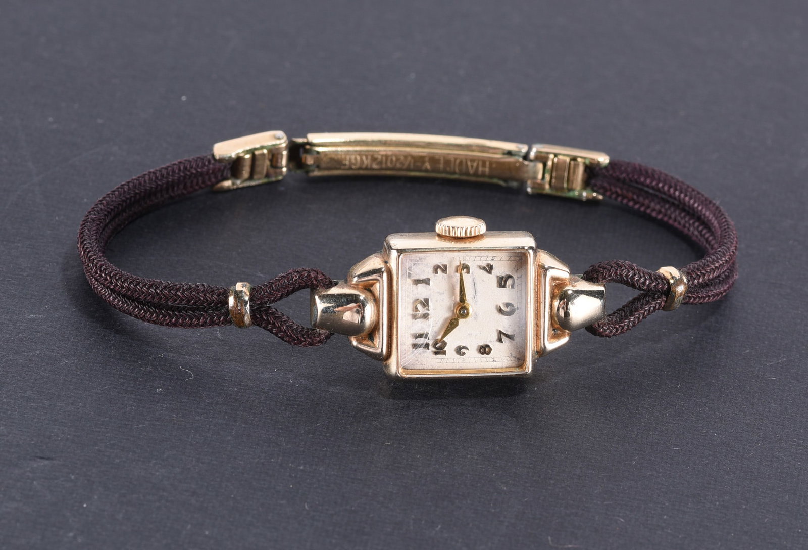Unmarked 10k gold filled ladies watch. Yellow gold color. Black cloth band. (1 of 2)