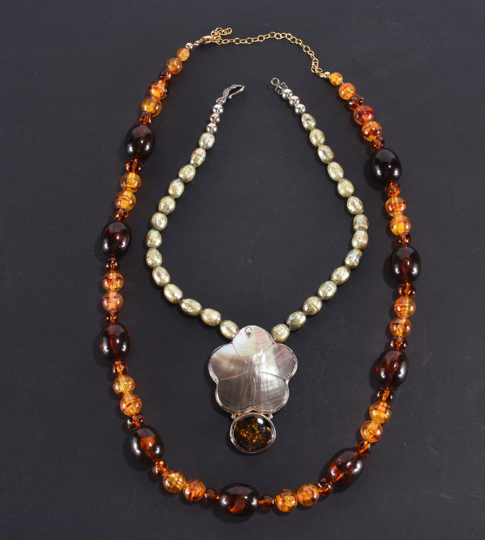 Formed amber along beaded necklace. Dark ovals and round beads. Gold filled clasp. 25" ?plus; (1 of 2)