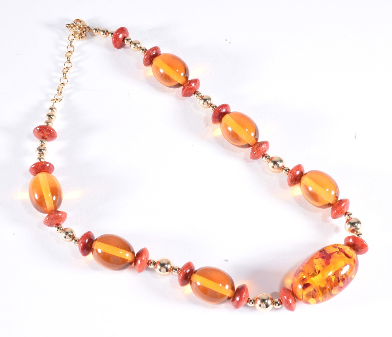 Formed amber oval beads with coral spacers. Gold Fill clasp. Gold tone beads. 19": Formed amber oval beads with coral spacers. Gold Fill clasp. Gold tone beads. 19"