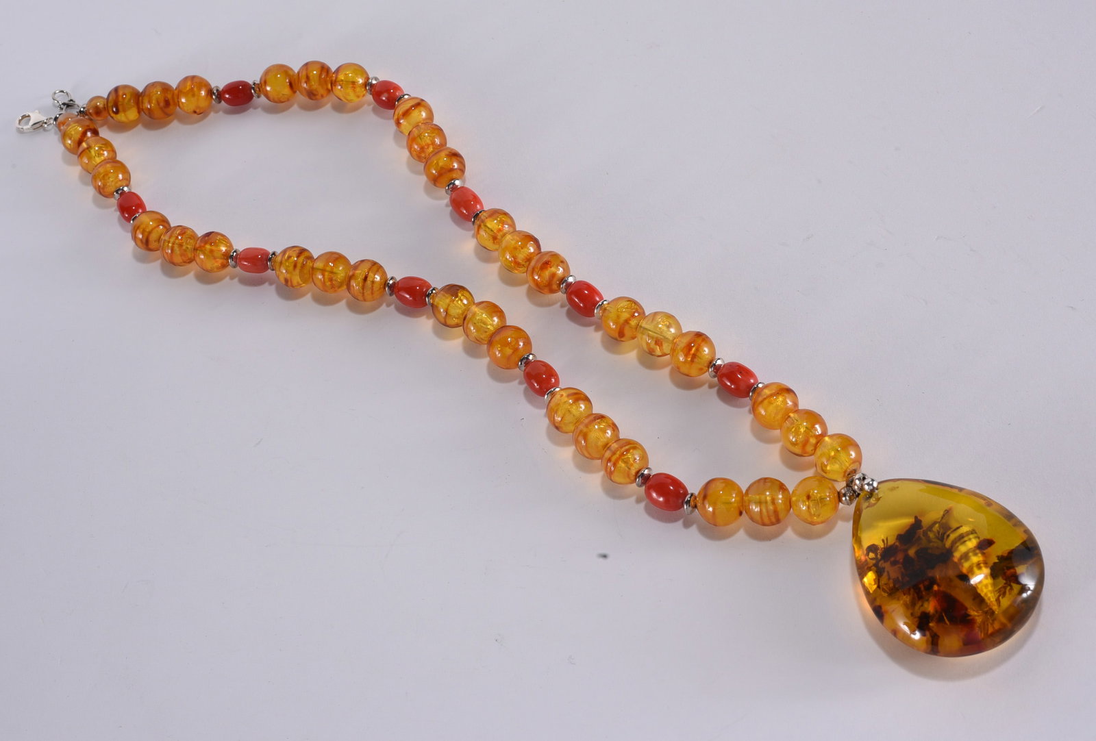 Pressed amber beaded necklace. With large pendant. Sterling Silver clasp. 24": Pressed amber beaded necklace. With large pendant. Sterling Silver clasp. 24"