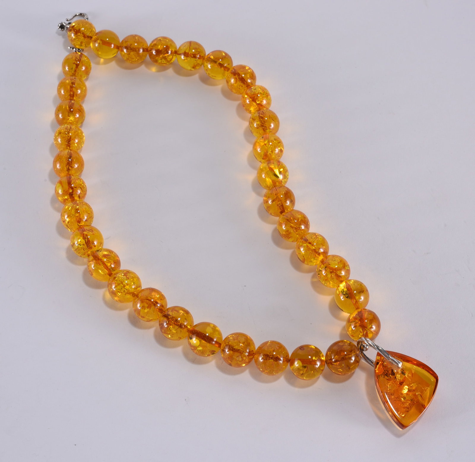 Formed amber large bead necklace. With triangle pendant. Sterling Silver clasp. 21": Formed amber large bead necklace. With triangle pendant. Sterling Silver clasp. 21"