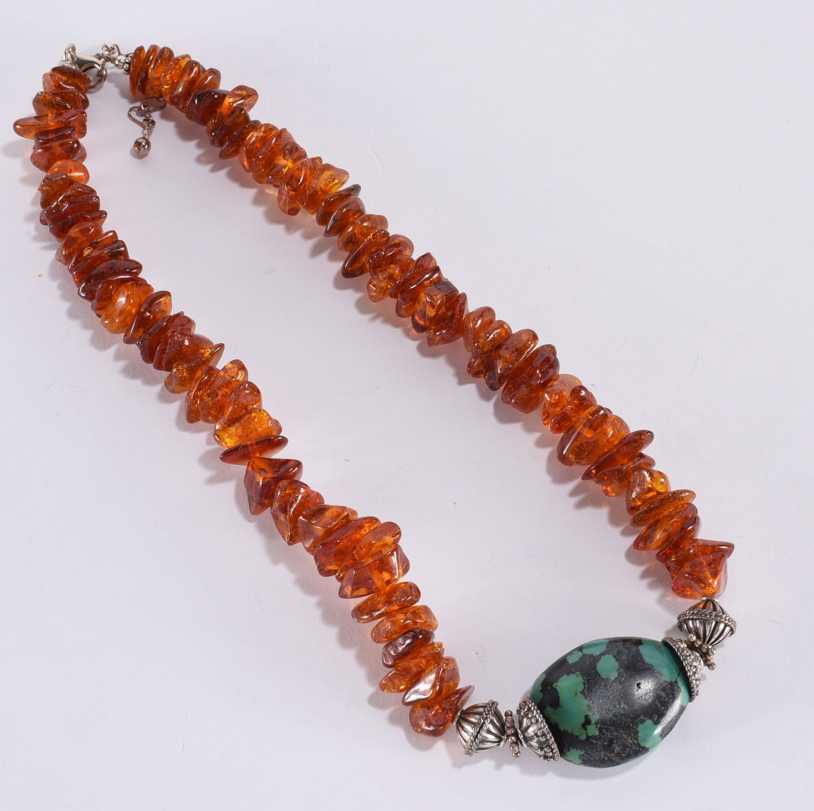 Amber rough nugget necklace with turqois center stone . Sterling Silver findings and clasp.: Amber rough nugget necklace with turqois center stone . Sterling Silver findings and clasp.