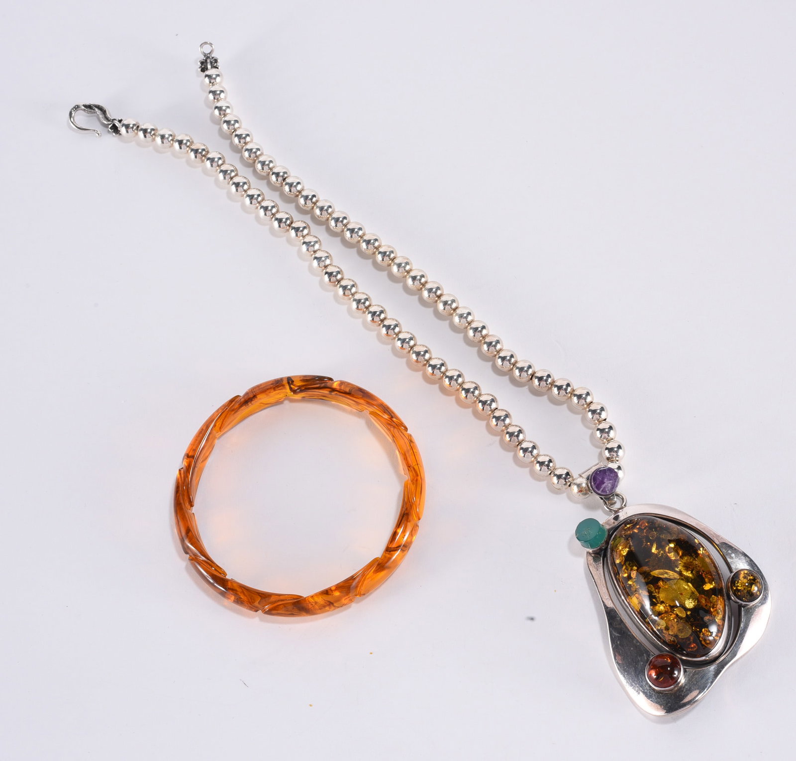 Sterling Silver Amber modern pendant on Sterling Silver bead necklace. Sterling Silver hook clasp.: Sterling Silver Amber modern pendant on Sterling Silver bead necklace. Sterling Silver hook clasp. 16" ?plus; Acrylic amber color bangle bracelet 2-3/8"