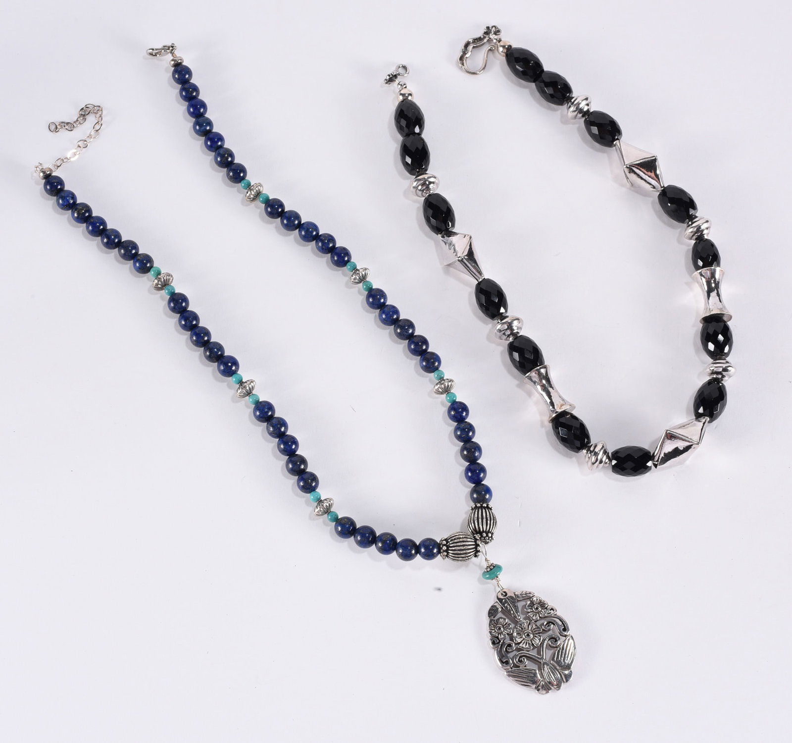 Faceted black oval bead necklace w/ various silver toned shaped spacers. Sterling Silver hook.: Faceted black oval bead necklace w/ various silver toned shaped spacers. Sterling Silver hook. 17"?plus; Lapis & turqois beaded necklace with Sterling Silver floral & butterfly pendant. 18"