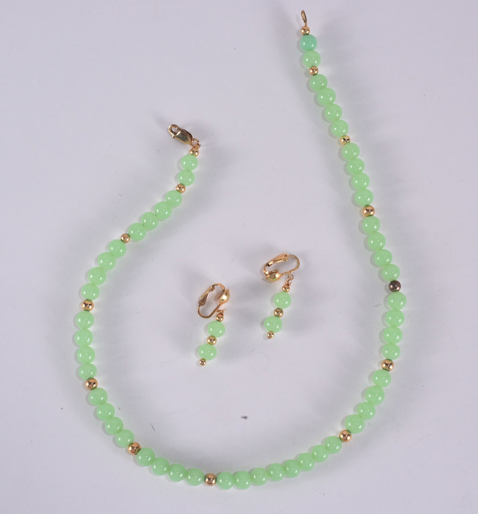 Light green agate bead necklace with gold tone bead accents. Gold Fill clasp and clip earrings.: Light green agate bead necklace with gold tone bead accents. Gold Fill clasp and clip earrings. 16"